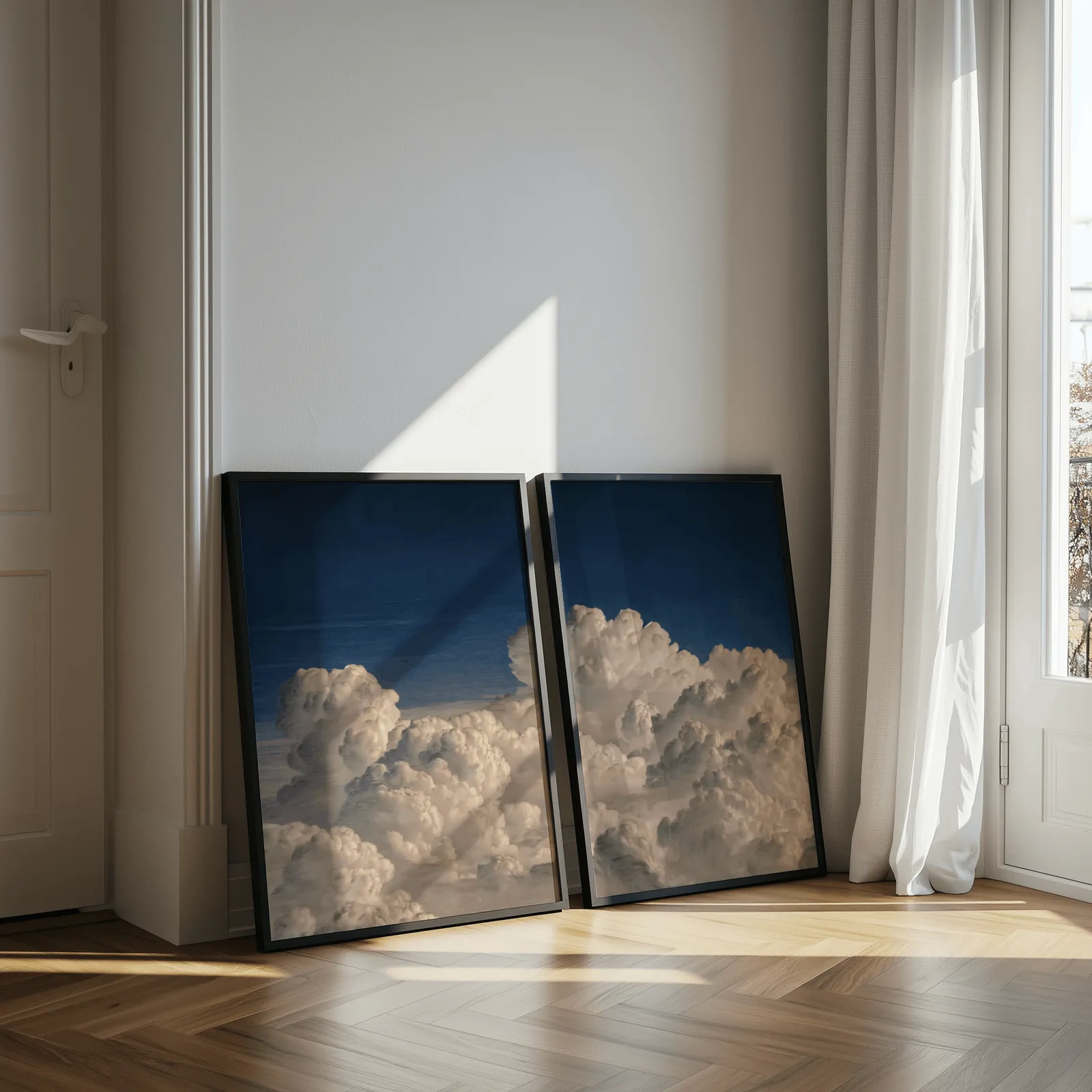 blue sky cloud landscape wall art set of two, leaning against a sunlit wall by herringbone floor and sheer curtains