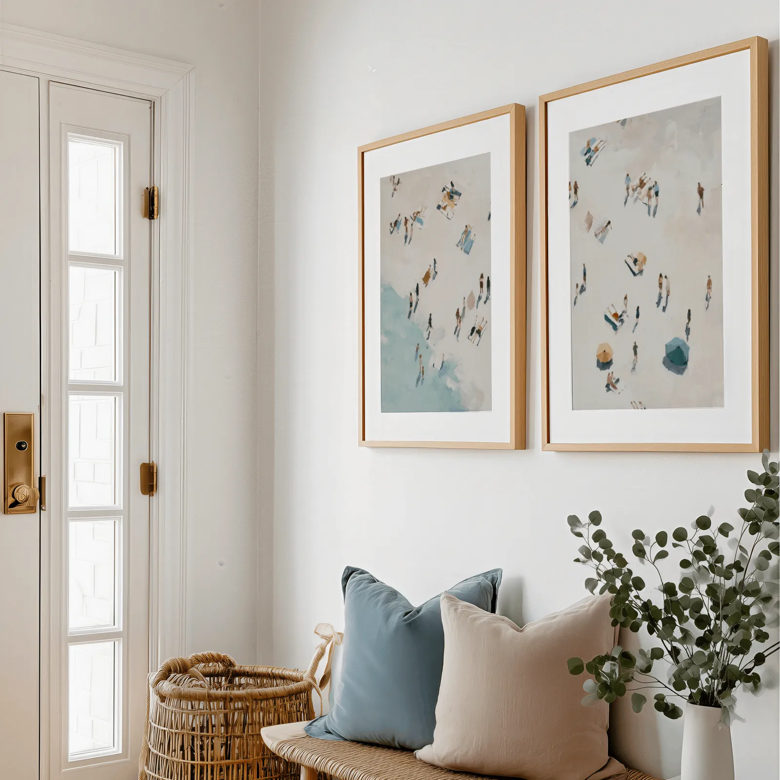 beach wall art set of 2 aerial coastal scene, above a bench with blue and blush pillows near the entry door