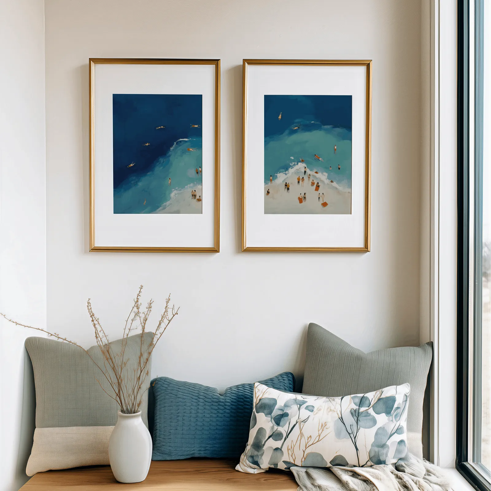 blue coastal beach wall art set of two aerial swimmers, above a cushioned window seat with sage and blue pillows