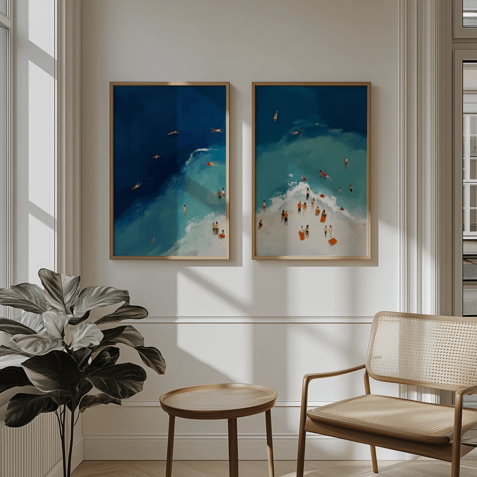 blue coastal beach wall art set of two aerial swimmers, above wainscoting beside a cane armchair and fiddle-leaf fig