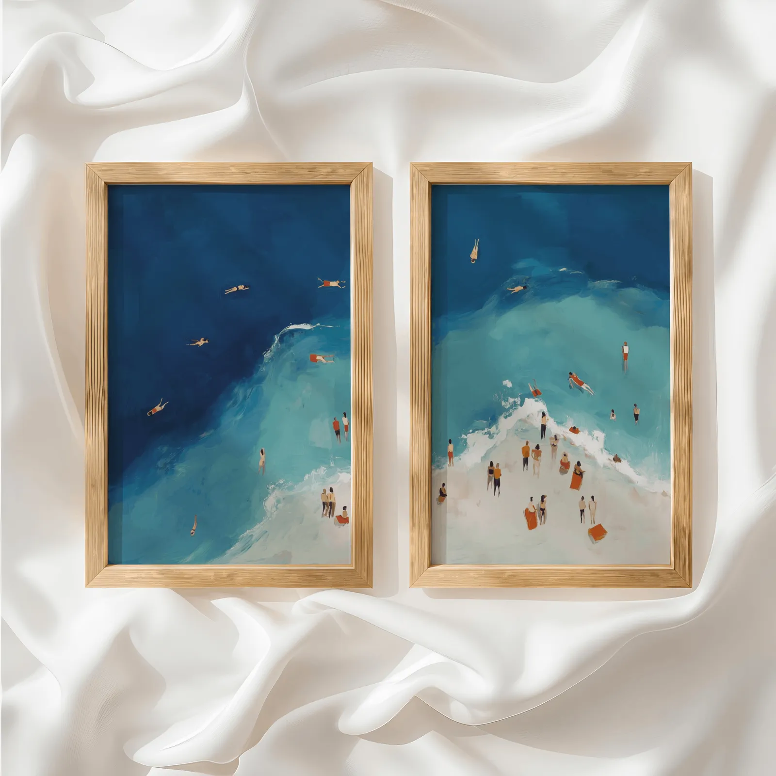 blue coastal beach wall art set of two aerial swimmers, side by side atop rumpled white silky fabric
