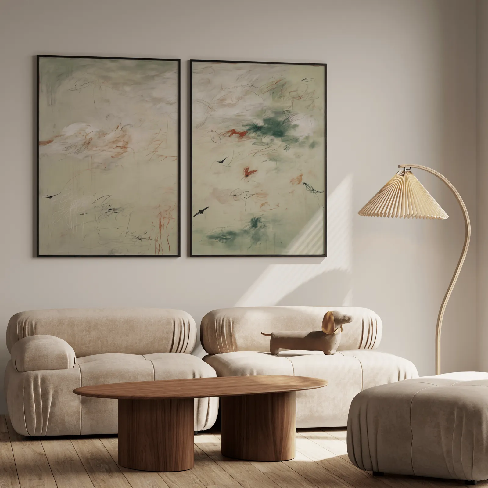 abstract bird wall art set in green and terracotta, above a plush beige sofa with a pleated lamp nearby