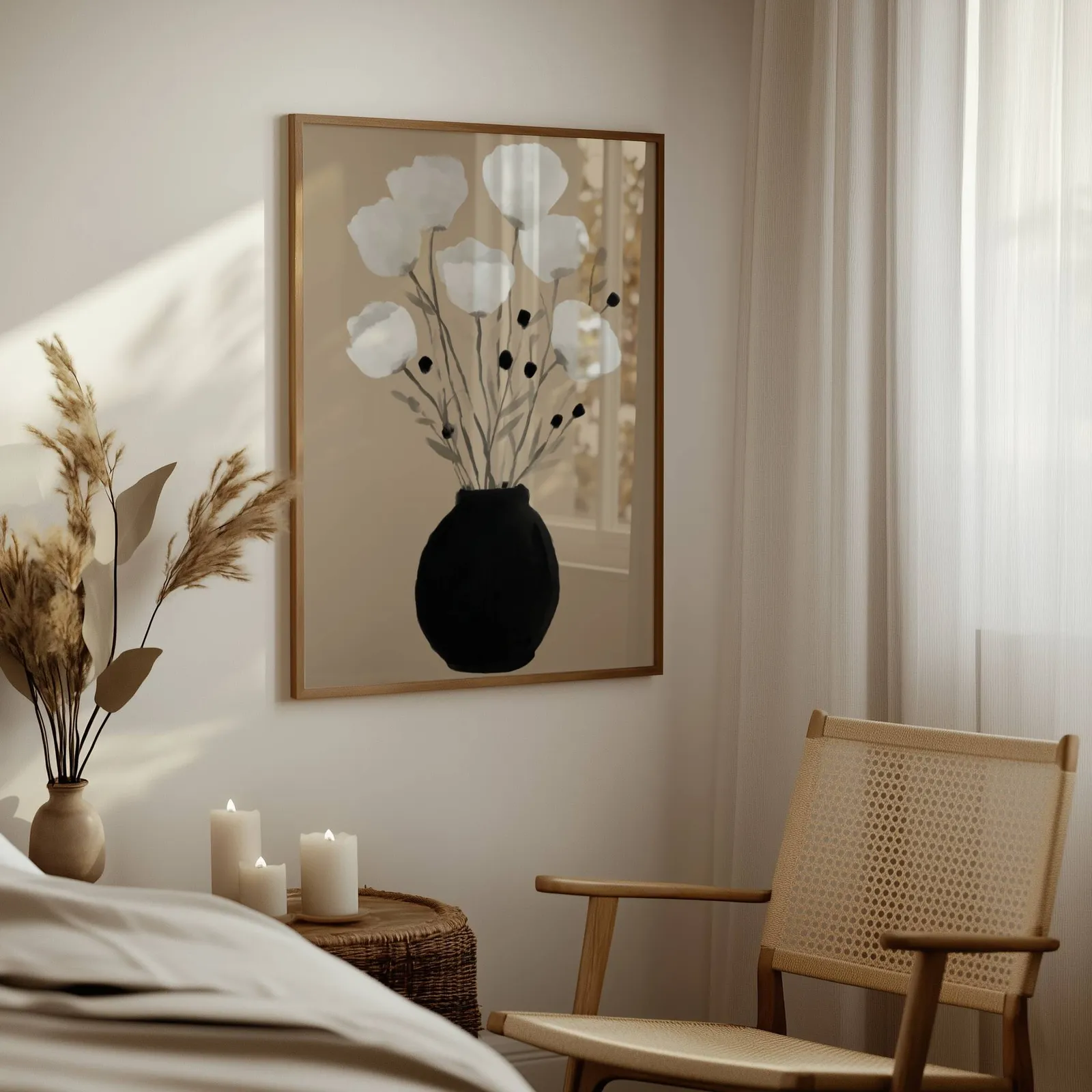 minimalist botanical wall art with black vase and white flowers, above a woven side table with lit candles and pampas grass
