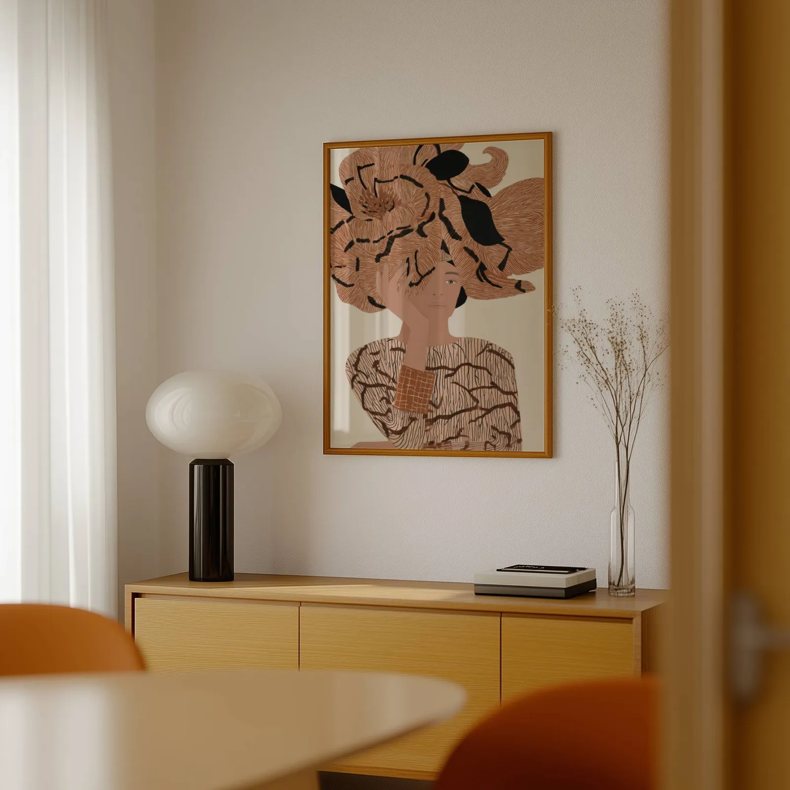 terracotta floral woman portrait abstract wall art, above a light wood sideboard beside a bulbous black lamp