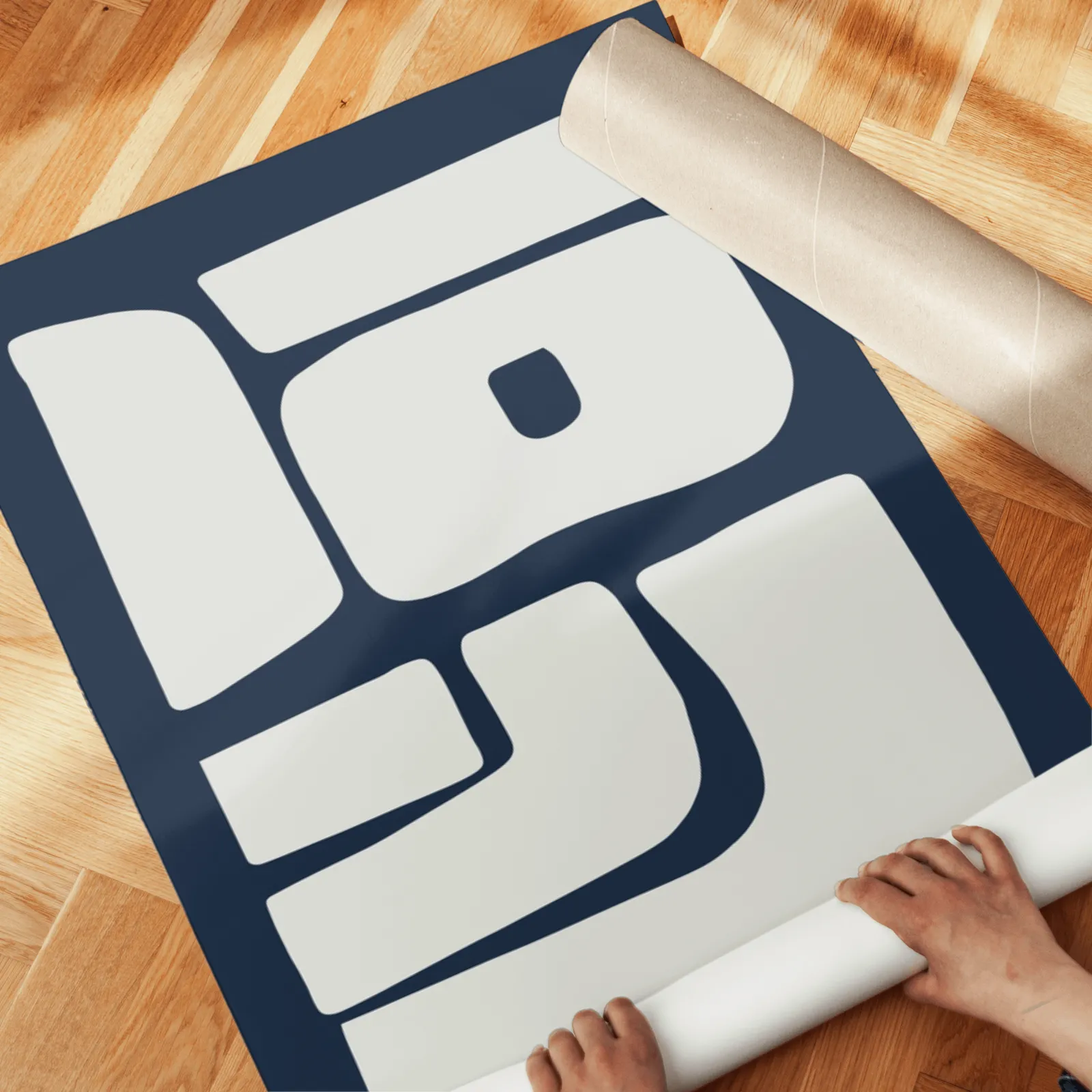 blue and grey abstract minimalist wall art set of two, unrolled across a herringbone parquet floor by hand