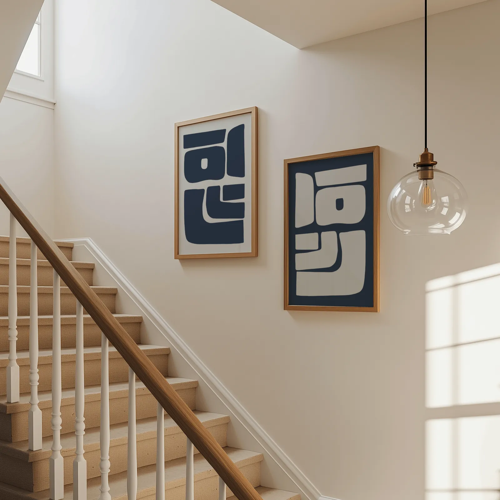 blue and grey abstract minimalist wall art set of two, beside a carpeted staircase under a glass pendant light