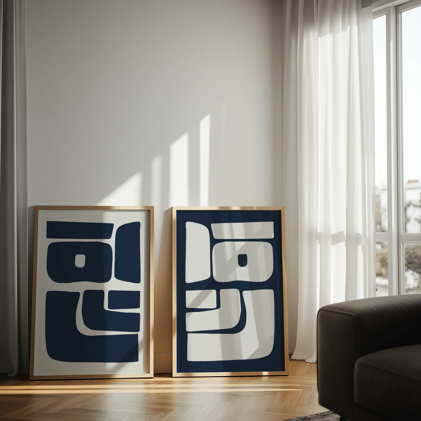 blue and grey abstract minimalist wall art set of two, leaning against a sunlit wall by sheer curtains