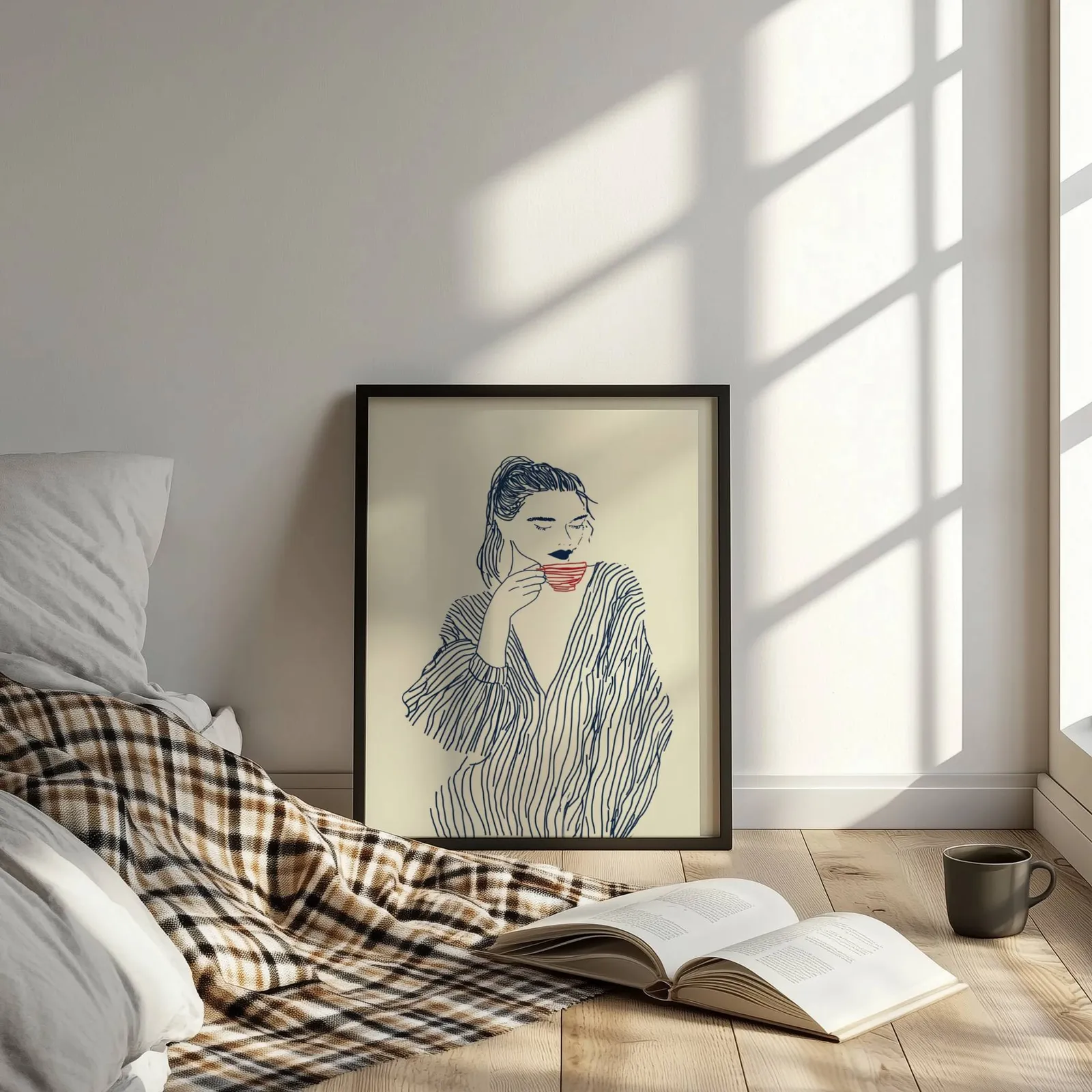 minimalist line art woman drinking coffee wall art, leaning on the floor beside a plaid throw and open book