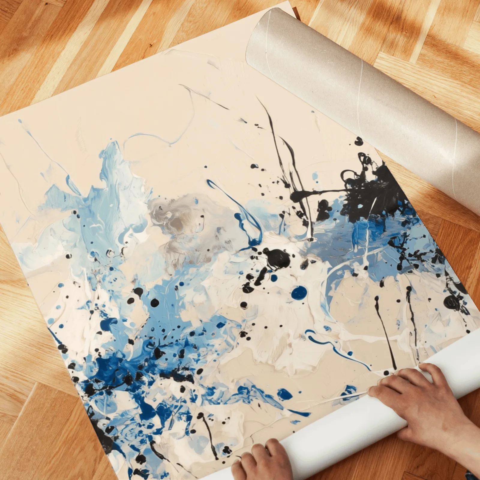 blue and black abstract splatter triptych wall art, unrolled across a herringbone wood floor by hand