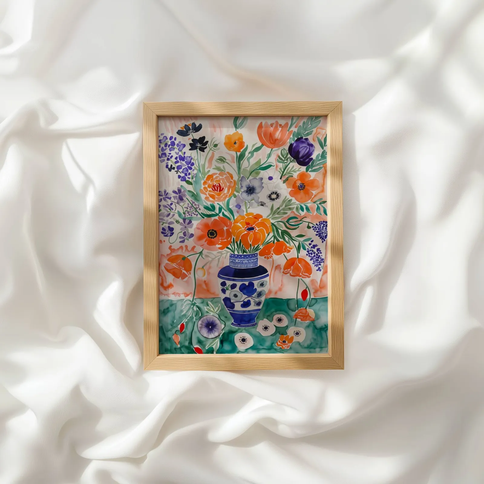 colorful floral wall art with blue vase, resting atop rumpled white silky fabric