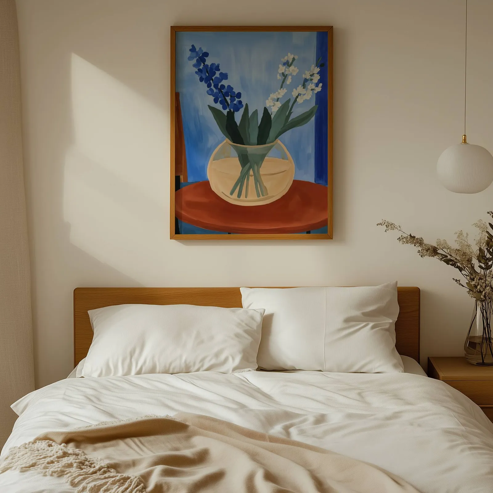 blue floral still life wall art in vase on terracotta table, above a wooden headboard with white linen pillows