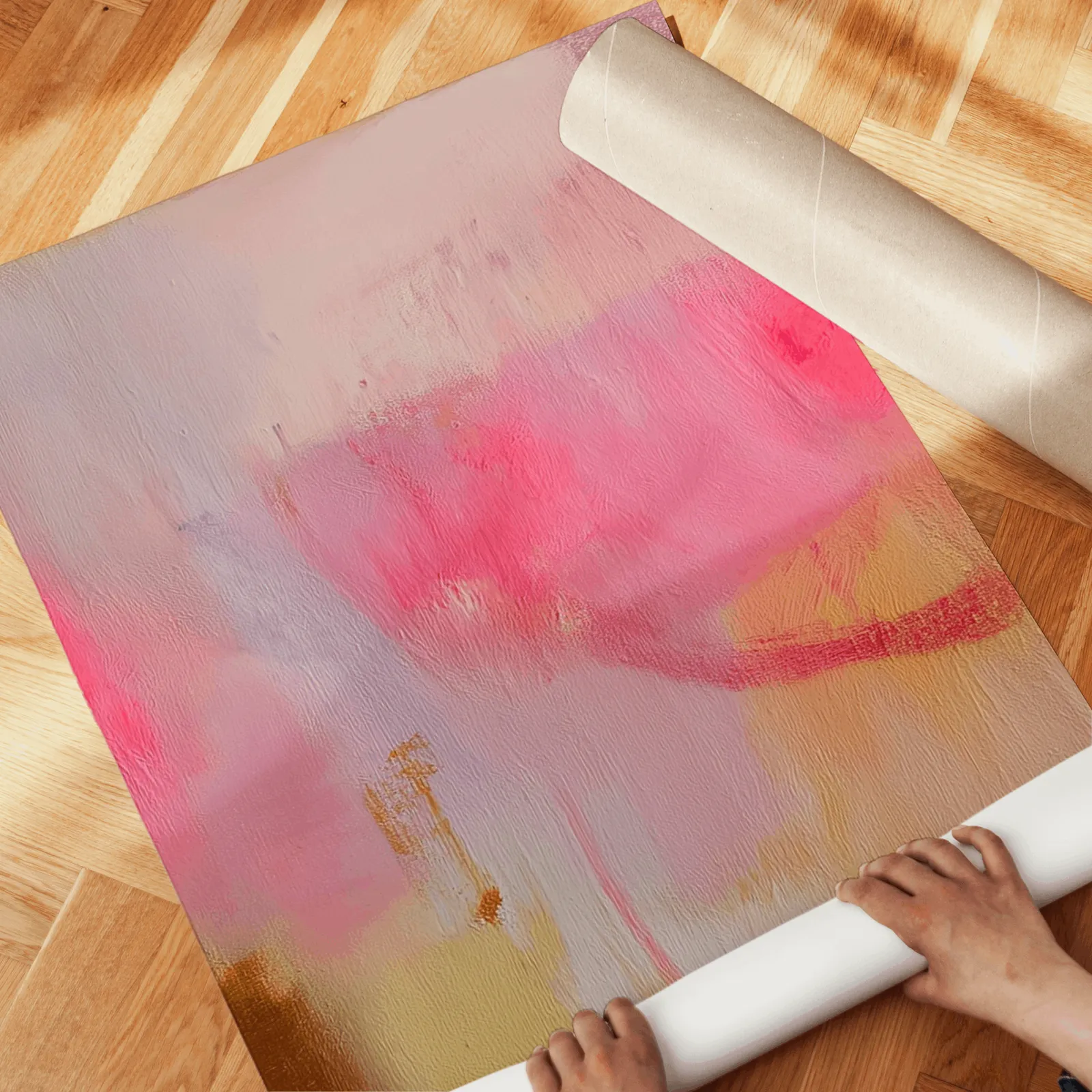 pink abstract wall art set of 3, unrolled across a herringbone wood floor by hand