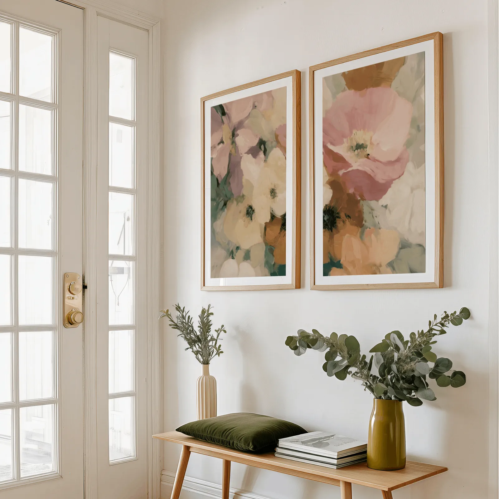 pink floral wall art set of two, above a wooden bench with eucalyptus stems and a green cushion
