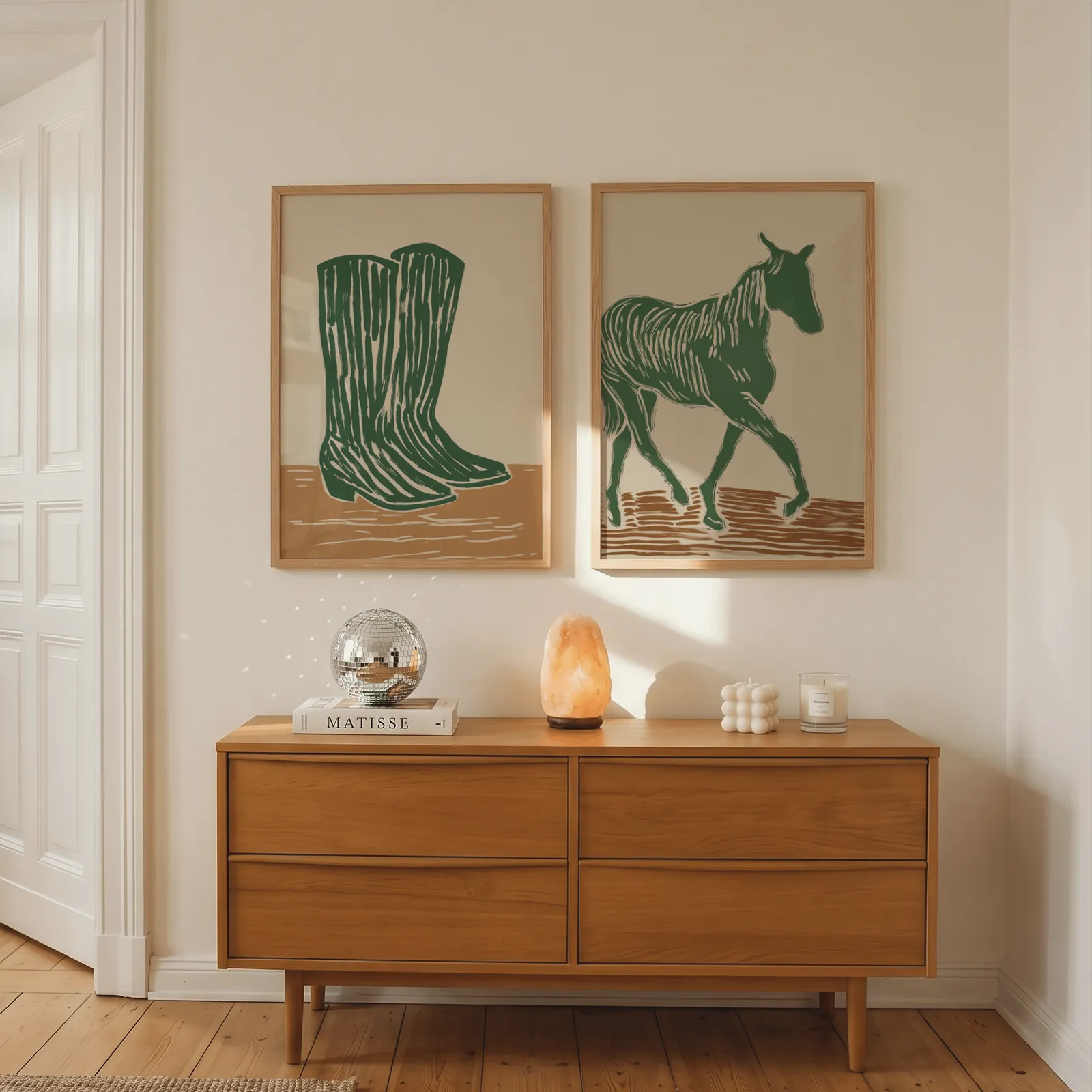 green western boots and horse wall art set, above a wooden dresser with a salt lamp and disco ball