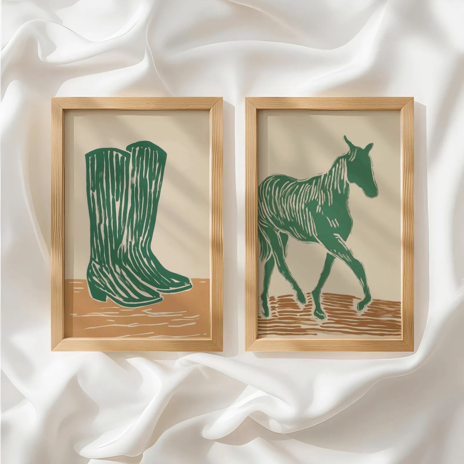 green western boots and horse wall art set, side by side atop rumpled white silky fabric