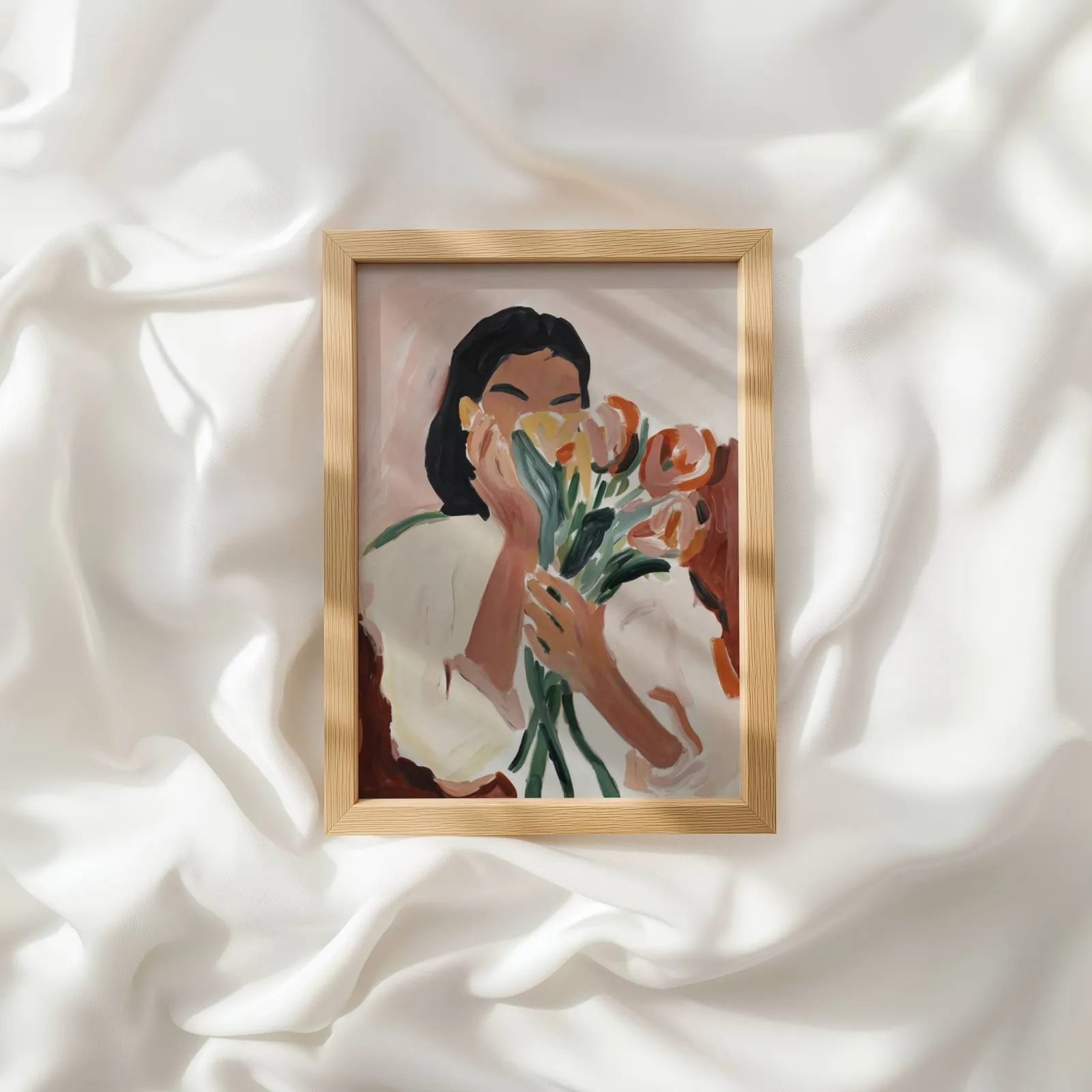 woman holding flowers abstract floral wall art, resting atop rumpled white silky fabric