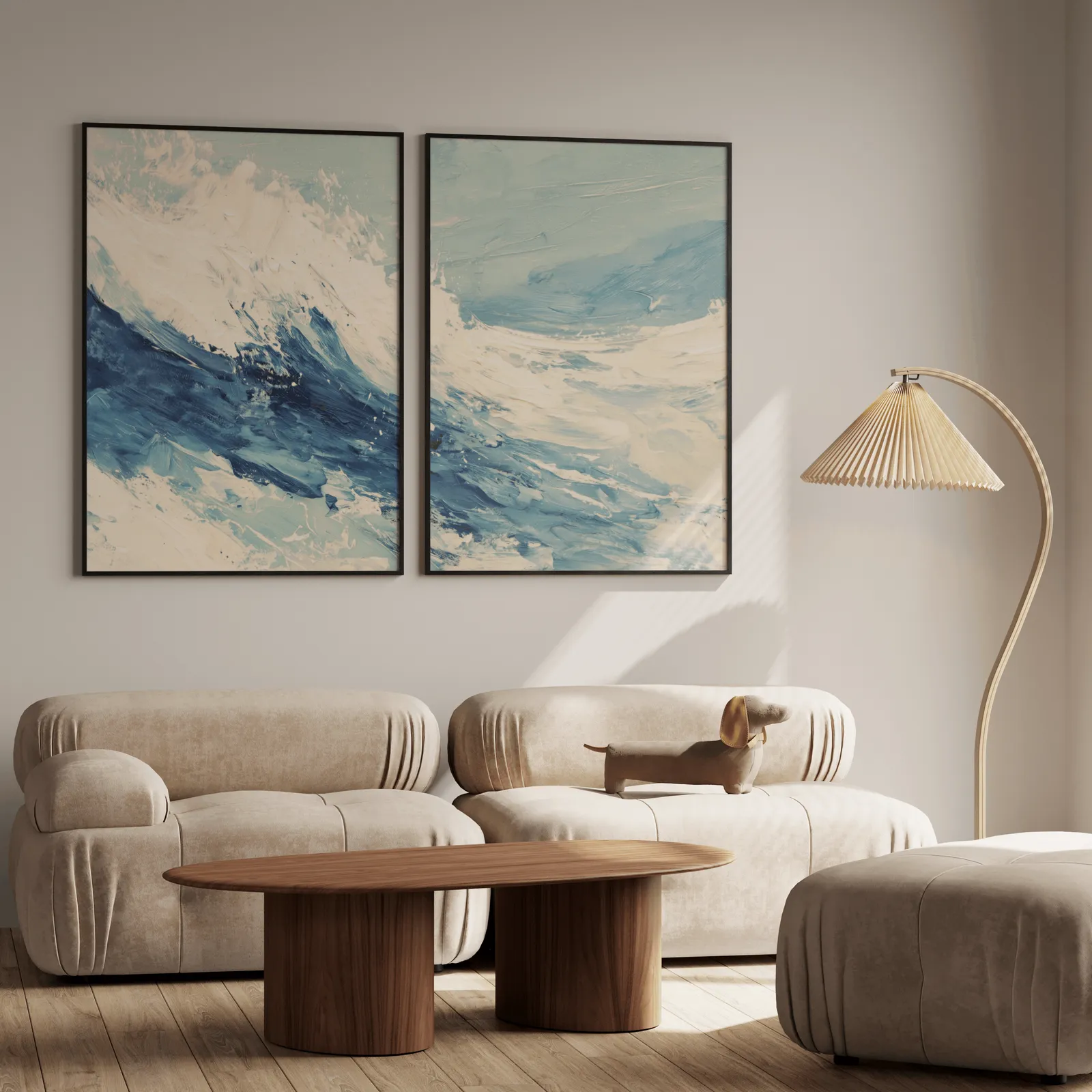 blue ocean wave abstract wall art set of two, above a plush beige sofa with a pleated lamp nearby