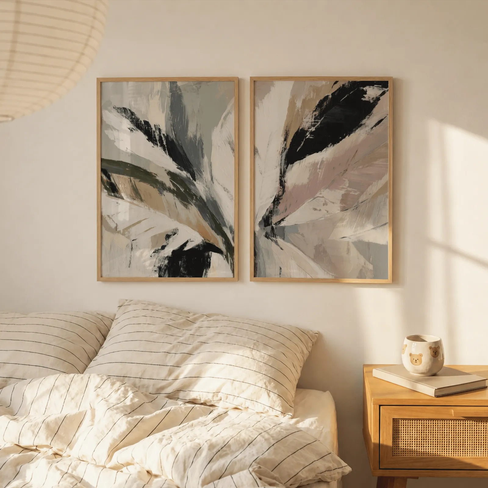 pink and green abstract botanical wall art set of 2, above a striped linen bed beside a paper lantern shade
