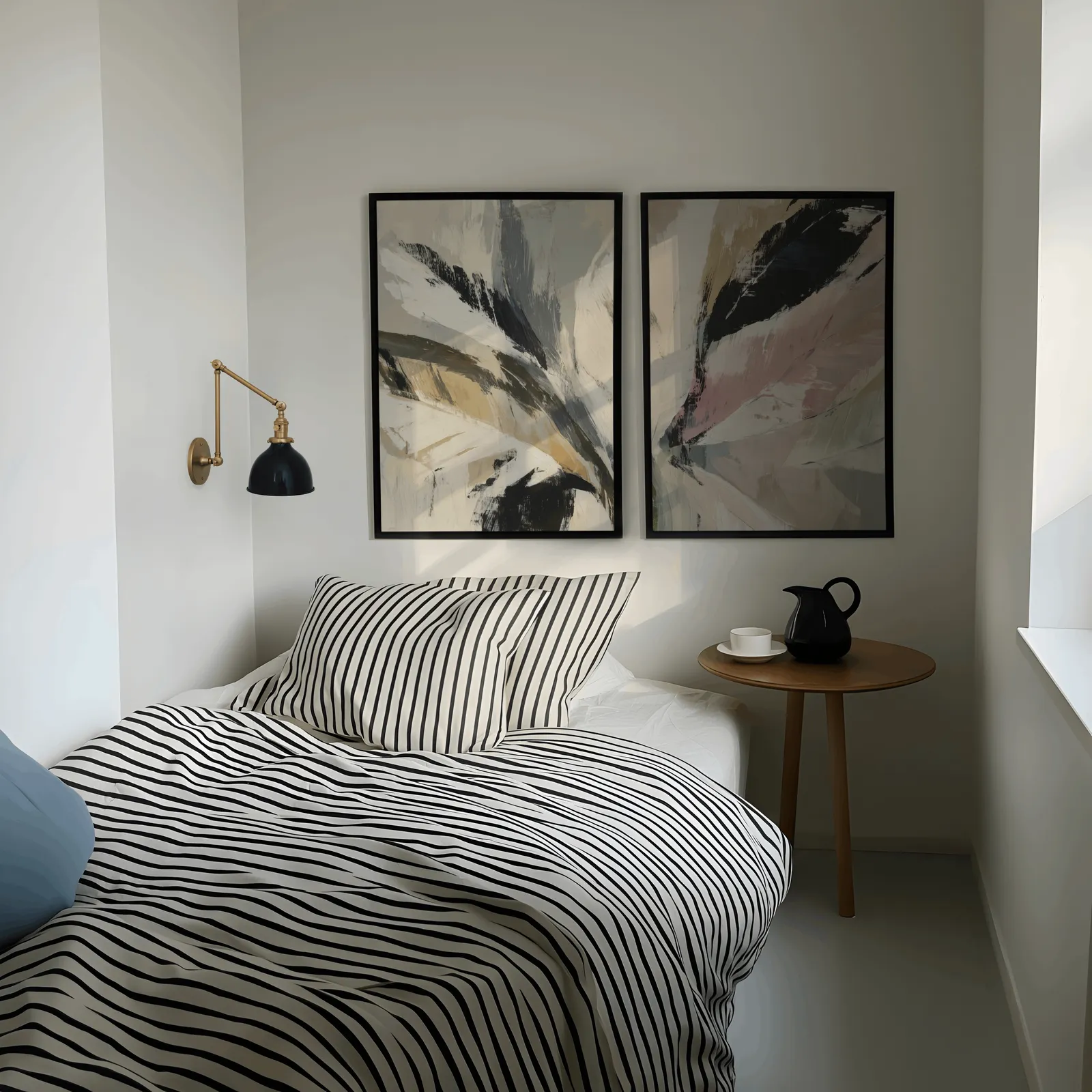 pink and green abstract botanical wall art set of 2, above a striped bed beside a brass swing-arm lamp