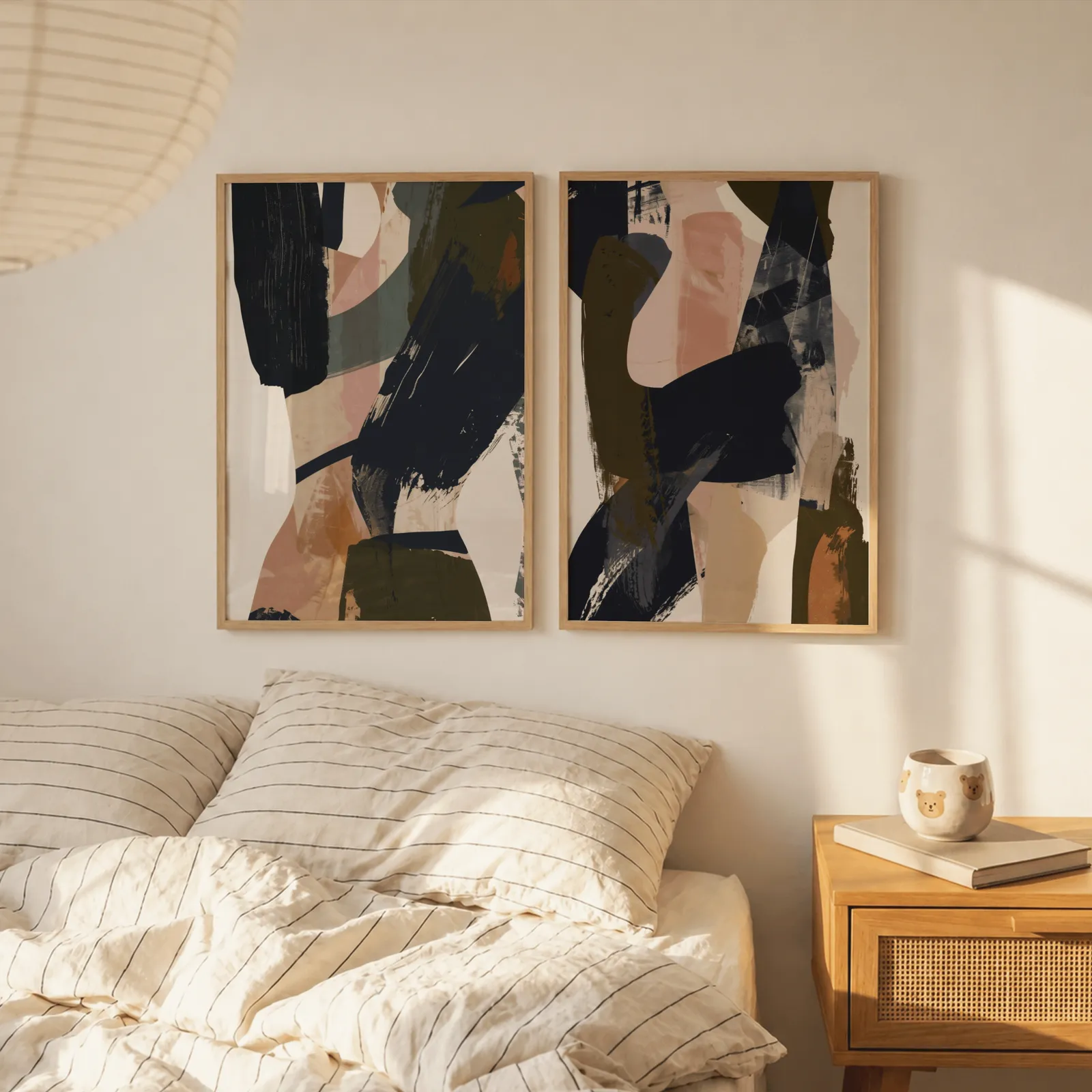 blue terracotta abstract wall art set of 2, above a striped linen bed beside a paper lantern shade