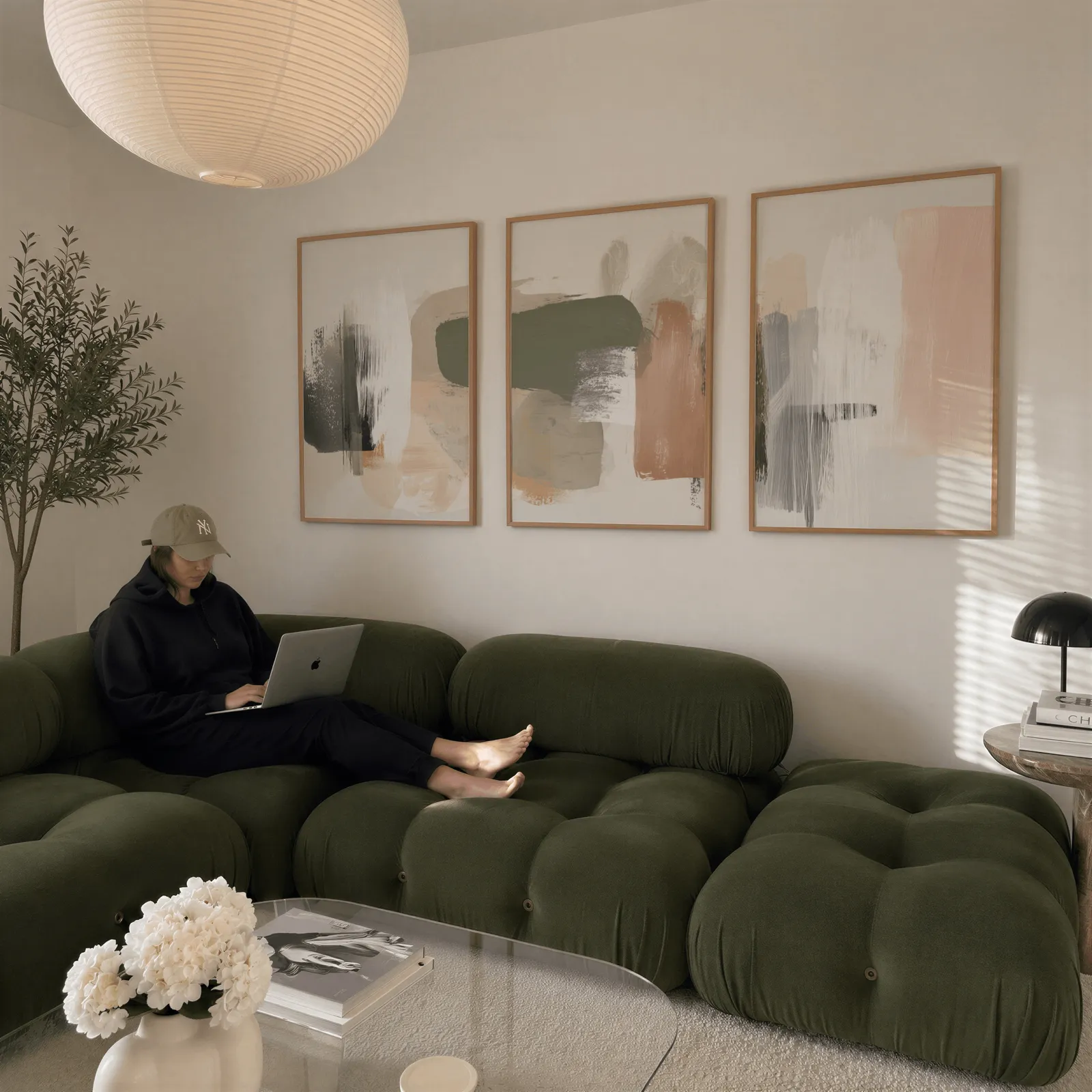 terracotta green abstract wall art set of 3, above a plush olive velvet sectional beneath a paper lantern light
