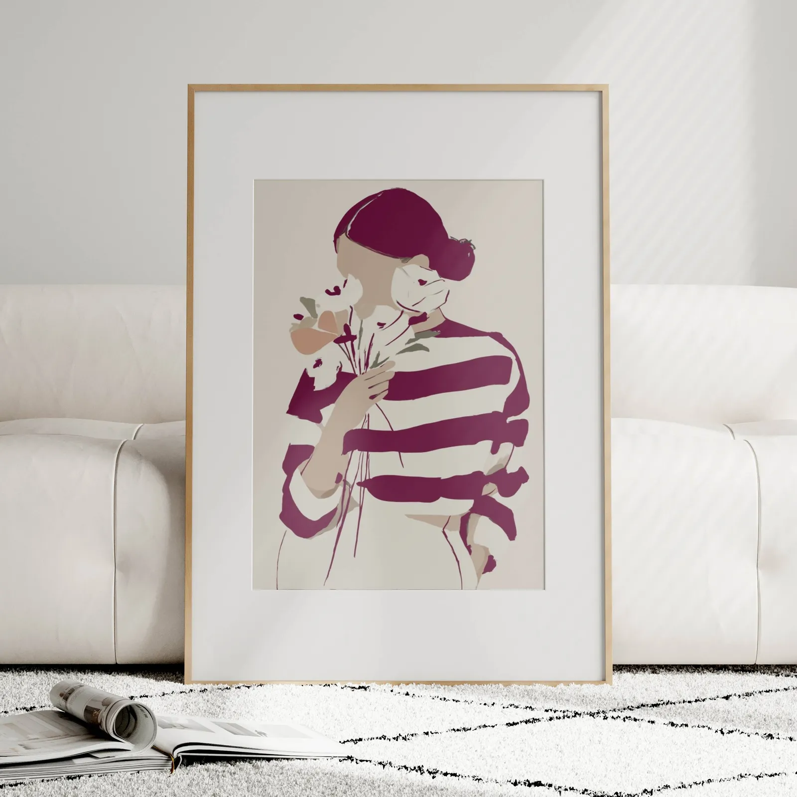 burgundy striped woman floral modern wall art, leaning against a plush cream sofa on a patterned rug