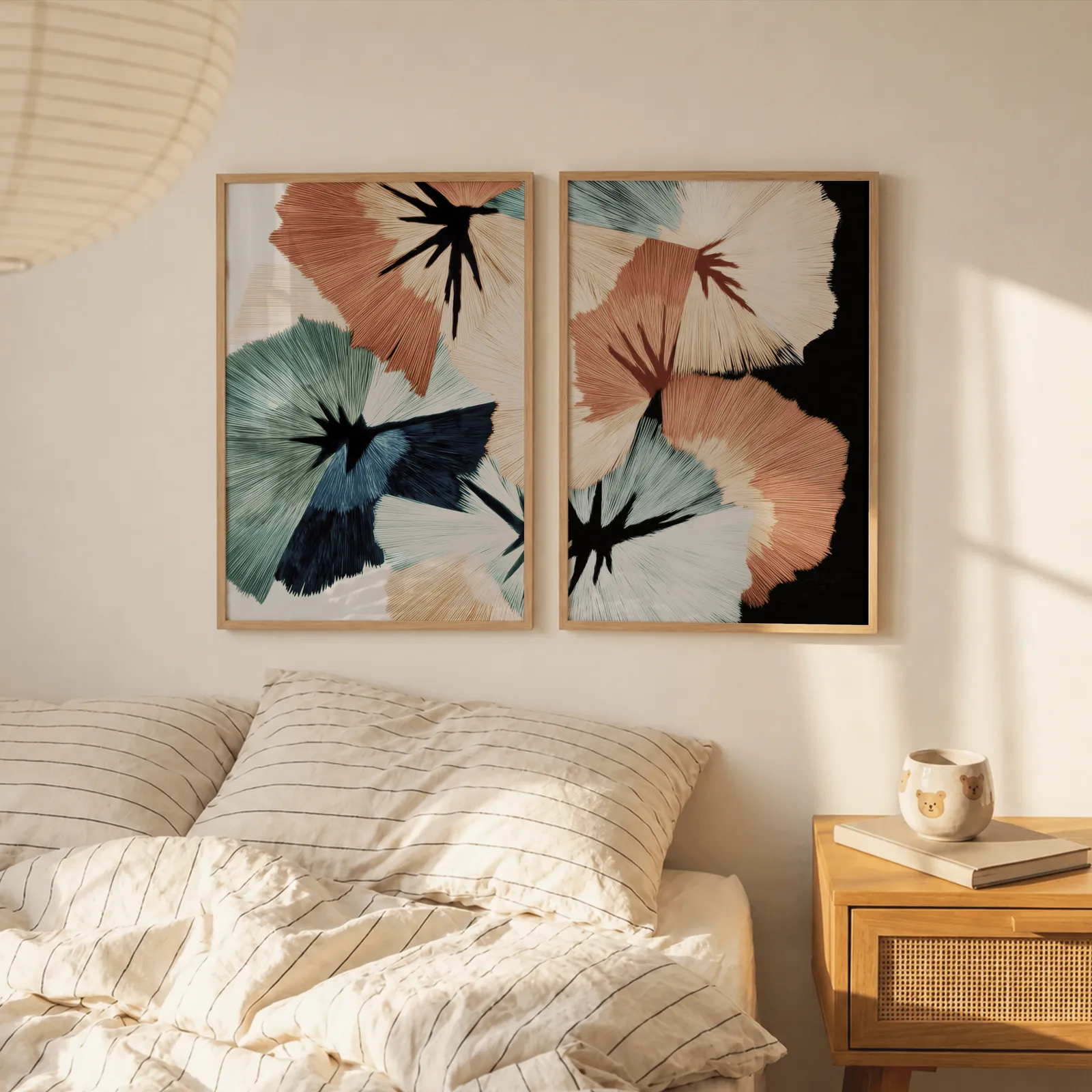 terracotta and teal abstract floral wall art set of two, above a striped linen bed beside a paper lantern shade