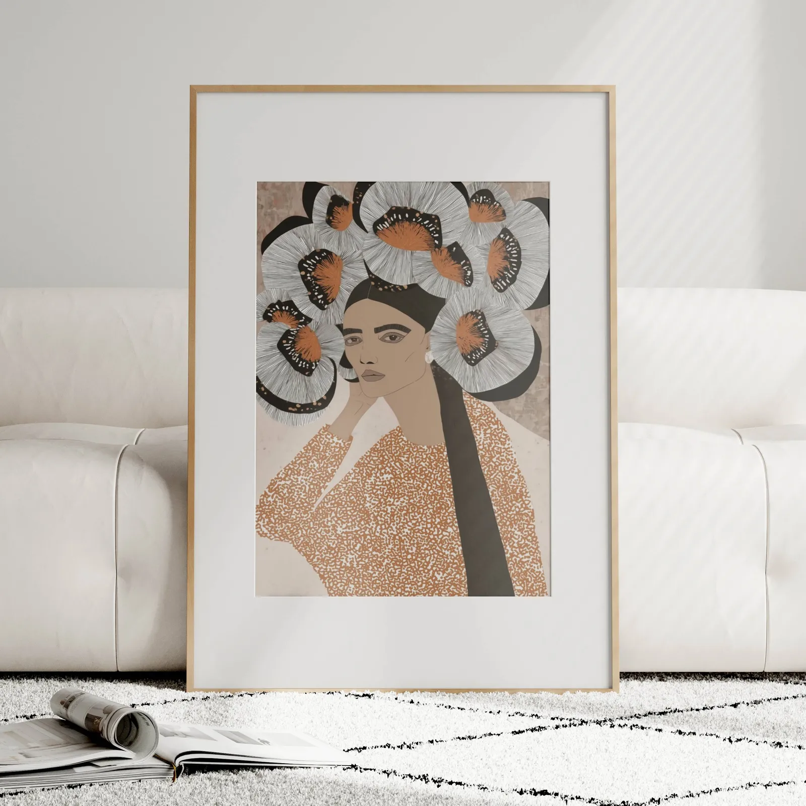 terracotta portrait wall art with butterfly crown, leaning against a plush cream sofa on a patterned rug