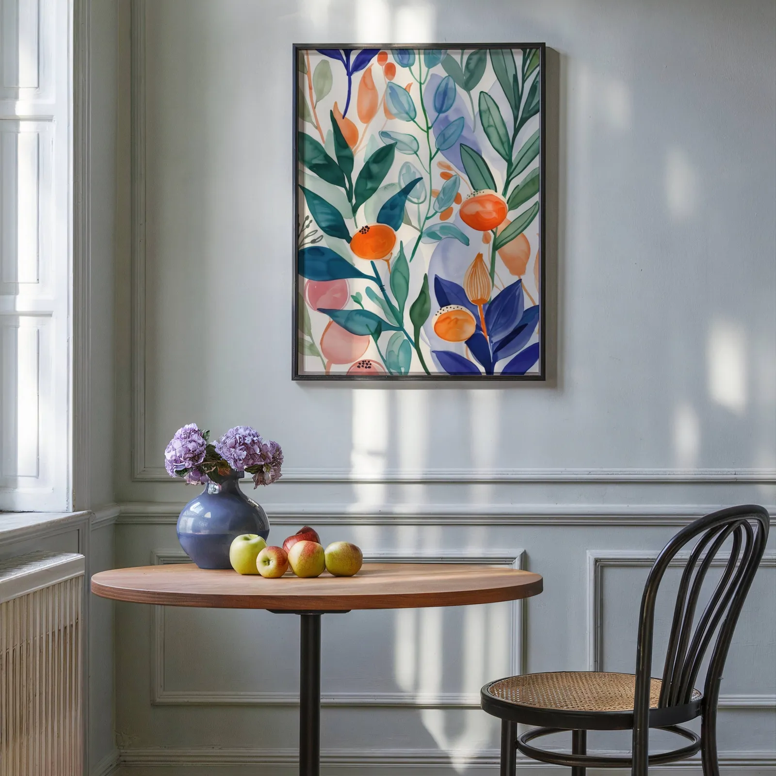 colorful botanical floral wall art, above a round wooden table with apples and a blue vase