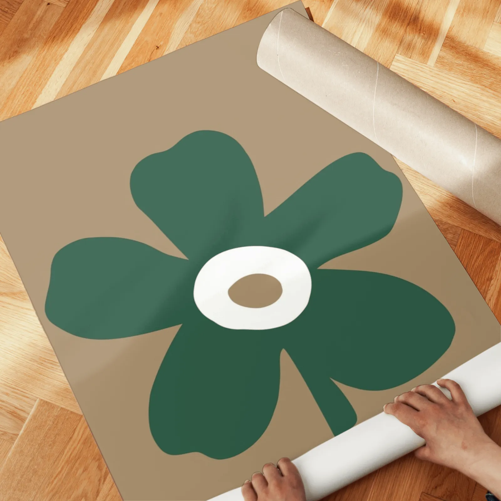 green and brown botanical flower wall art set of two, unrolled across a herringbone parquet floor by hand