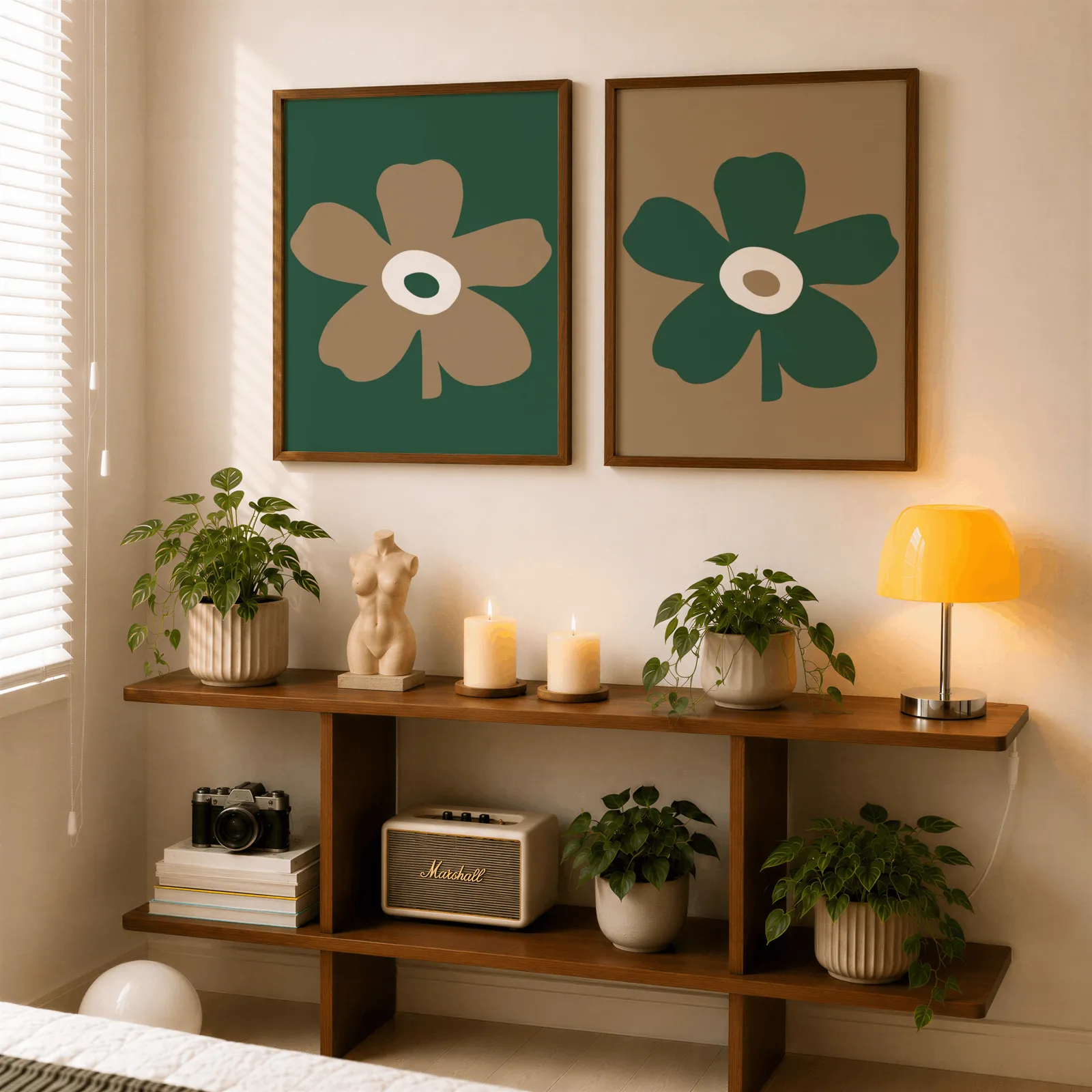 green and brown botanical flower wall art set of two, above a wooden console shelf with potted plants and a yellow lamp