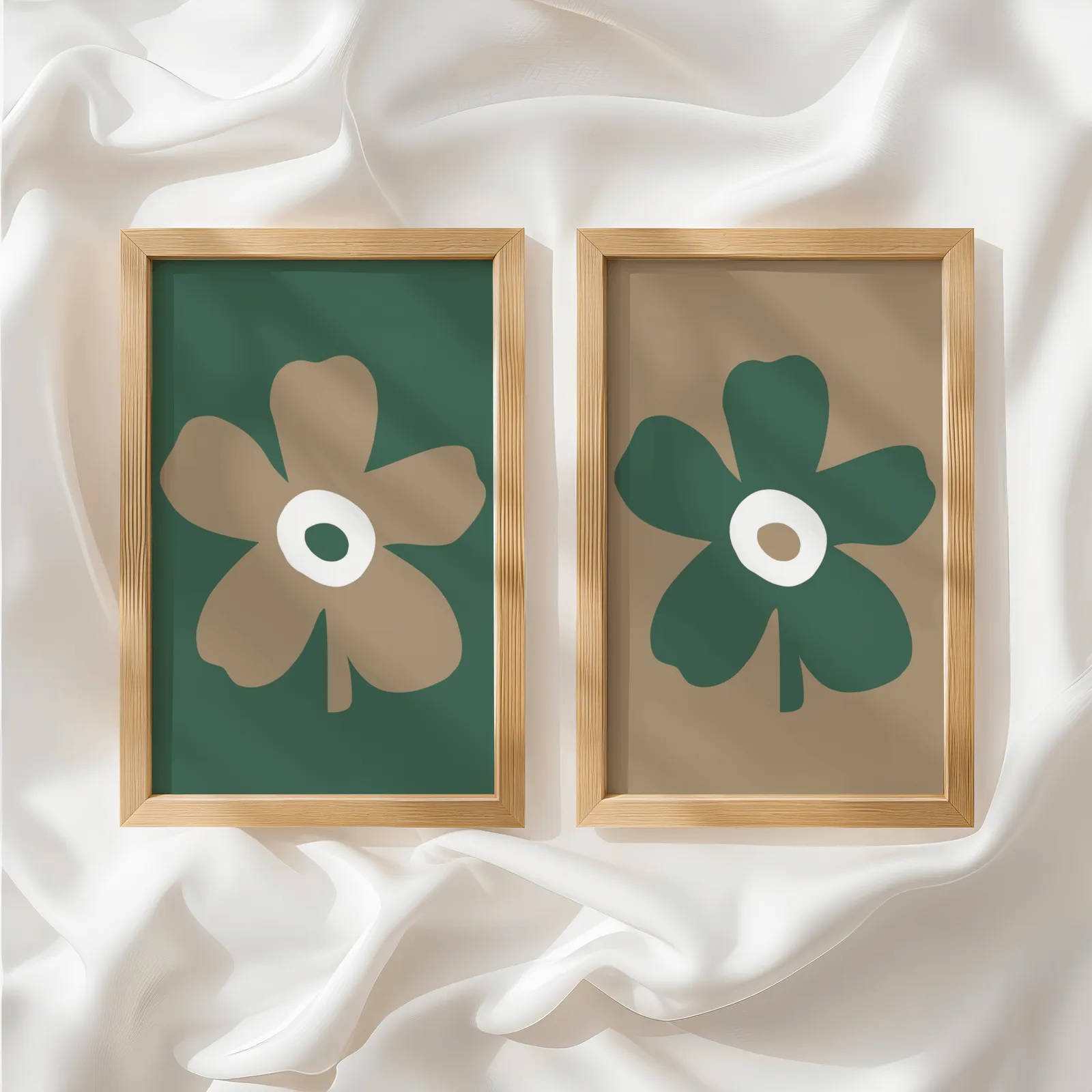 green and brown botanical flower wall art set of two, side by side atop rumpled white silky fabric