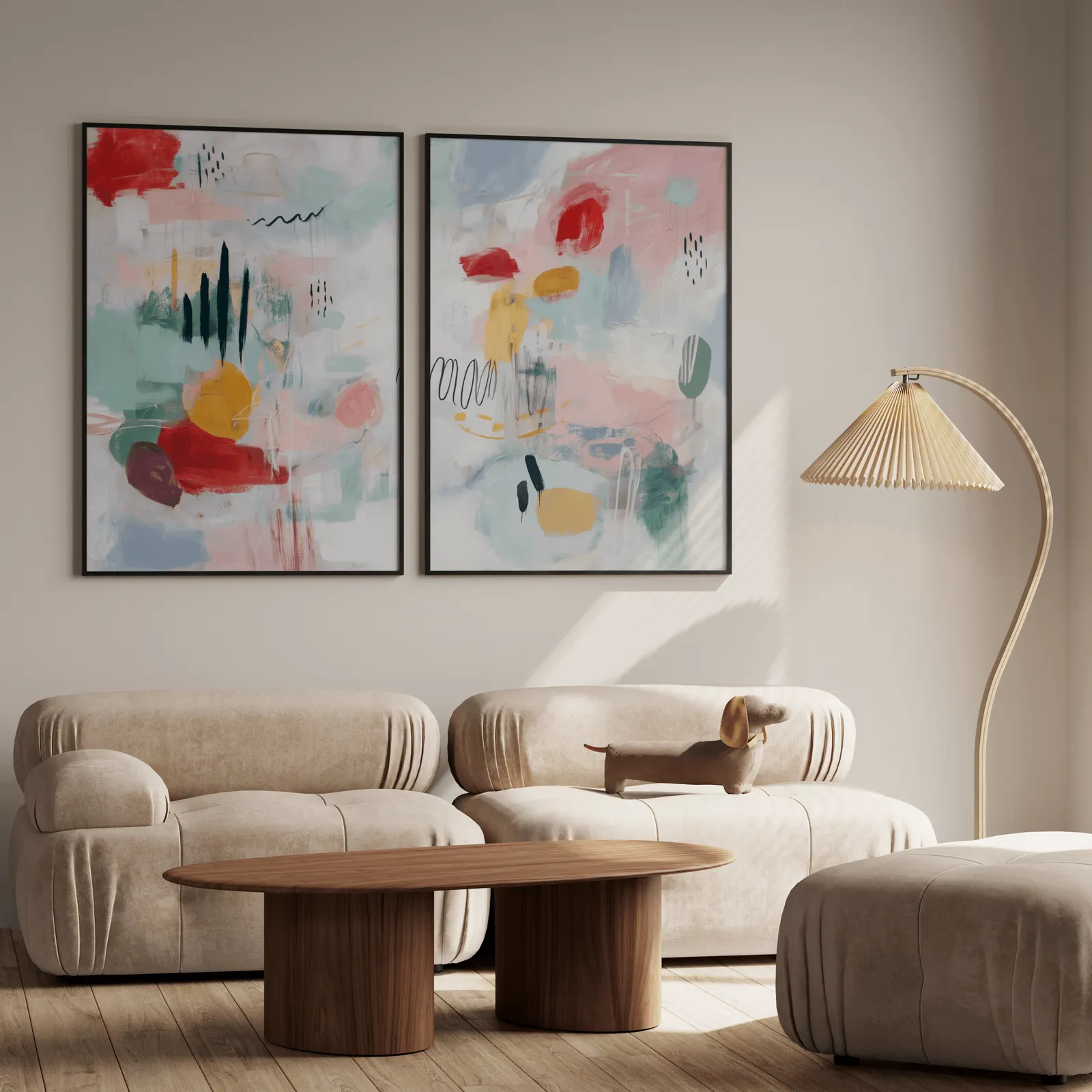 colorful abstract wall art set of 2 in pink and yellow, above a plush beige sofa with a pleated lamp nearby