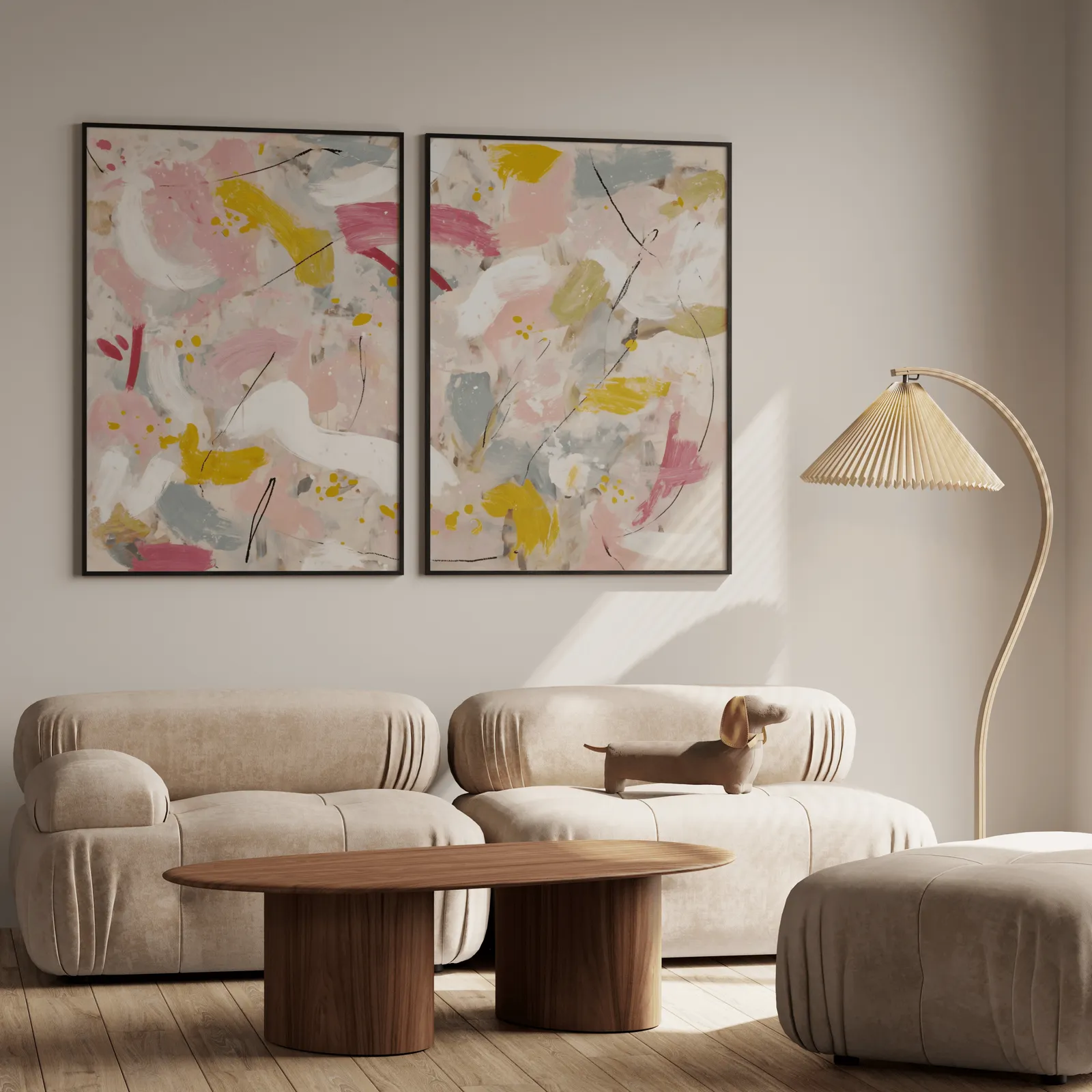 pink and yellow abstract wall art set of two, above a plush beige sofa with a pleated lamp nearby