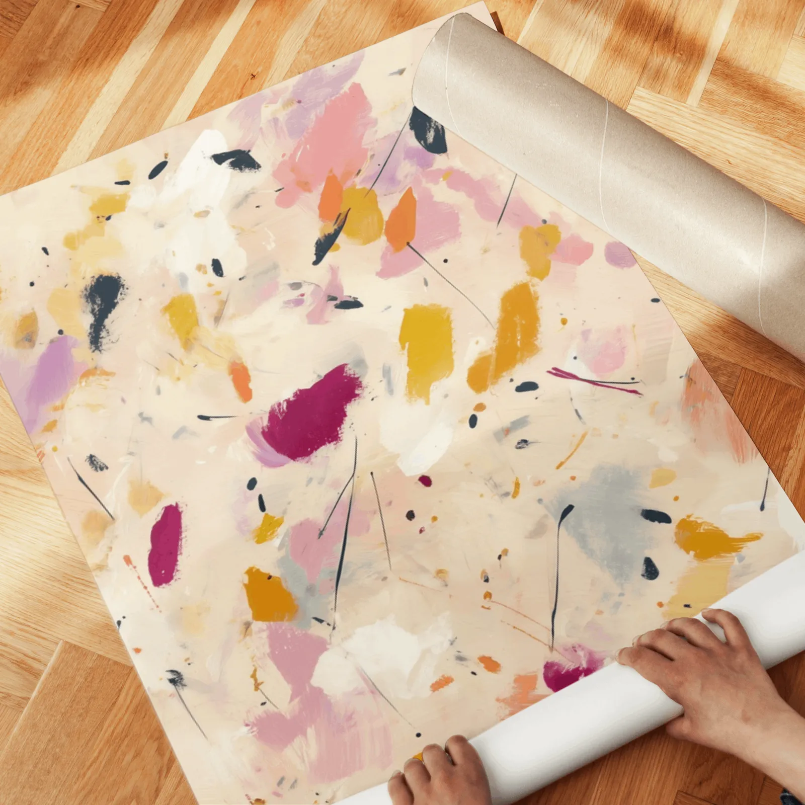 colorful abstract confetti wall art set of two, unrolled across a herringbone parquet floor by hand