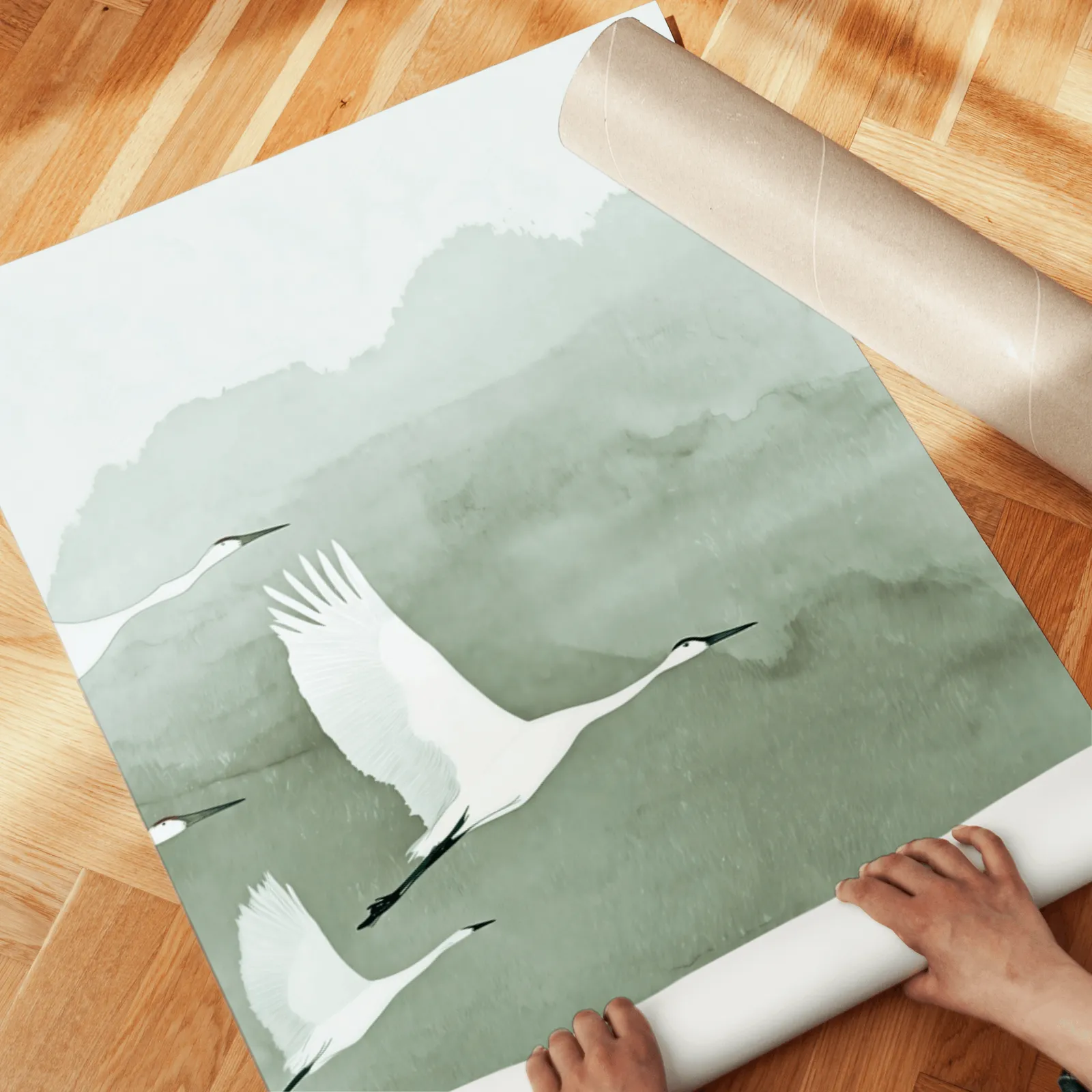 green crane wall art set of two prints, unrolled across a herringbone parquet floor by hand