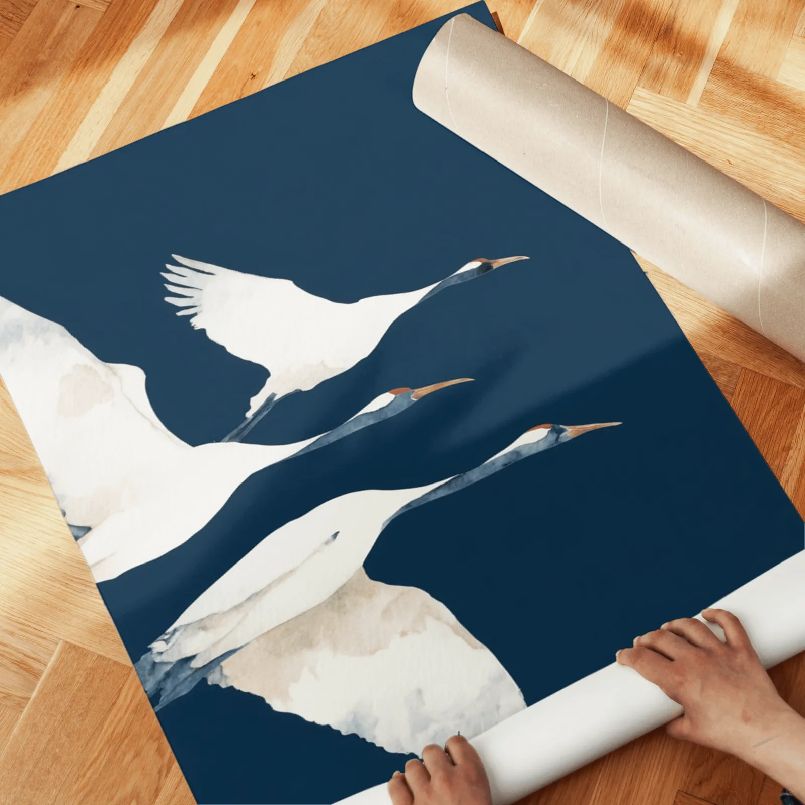 blue crane wall art set of two prints, unrolled across a herringbone parquet floor by hand