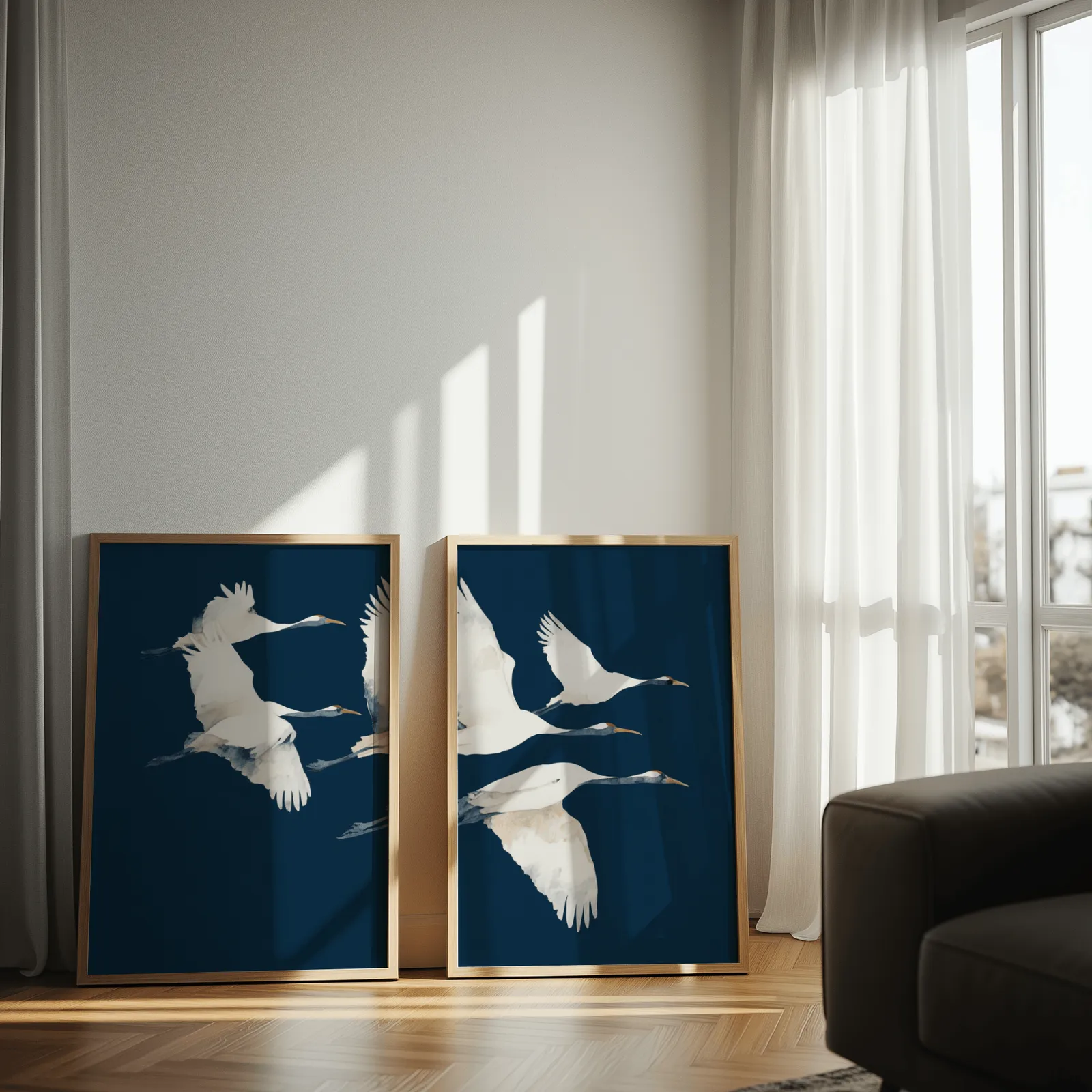 blue crane wall art set of two prints, leaning against a sunlit wall by sheer curtains