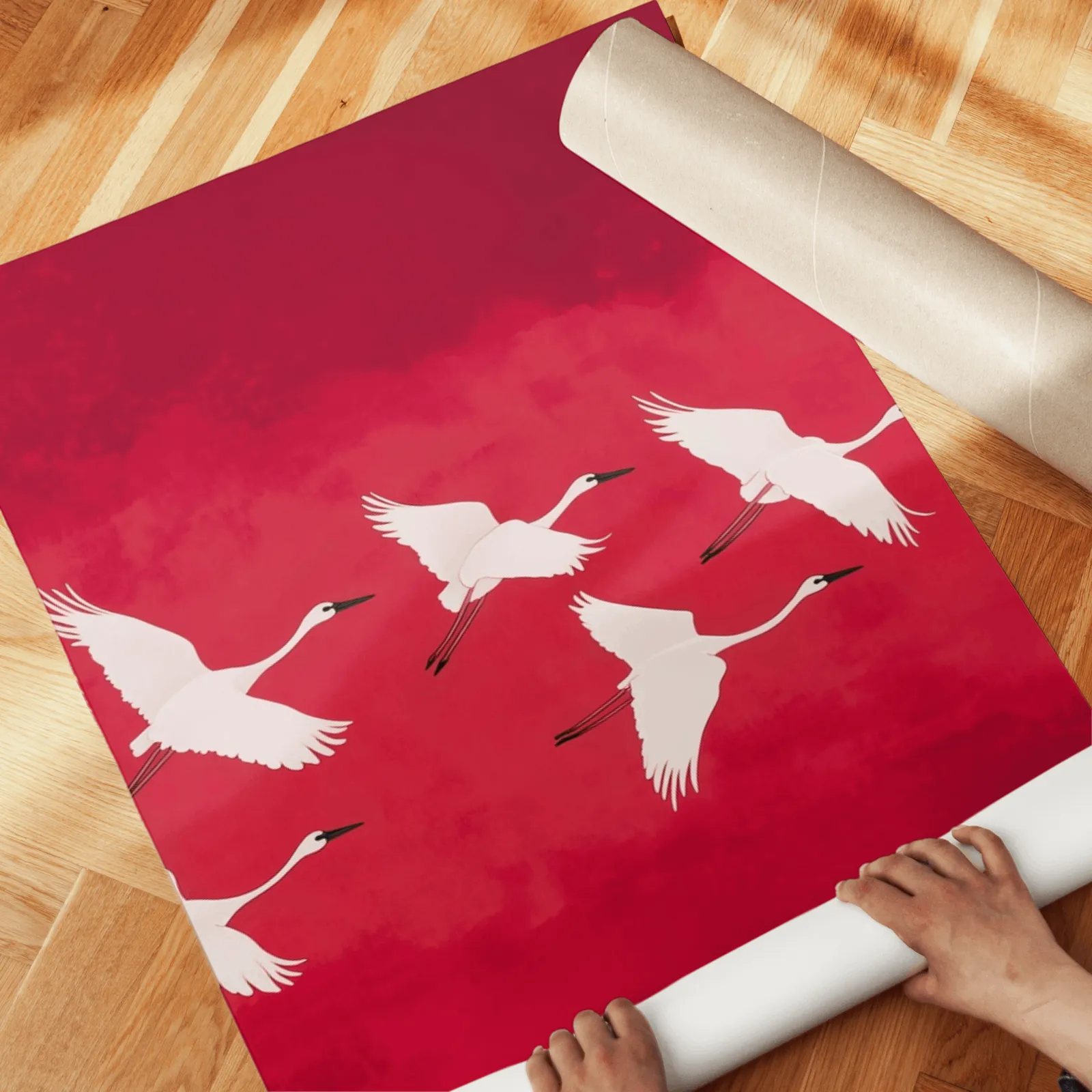 red crane wall art triptych, unrolled across a herringbone wood floor by hand