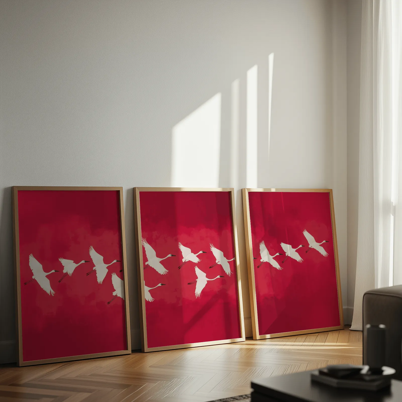red crane wall art triptych, leaning against a sunlit wall on herringbone flooring