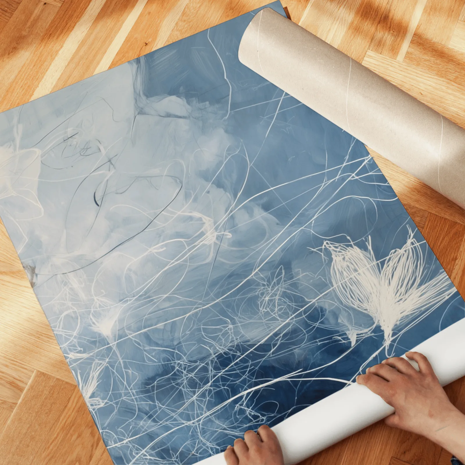 blue abstract floral triptych wall art, unrolled across a herringbone wood floor by hand