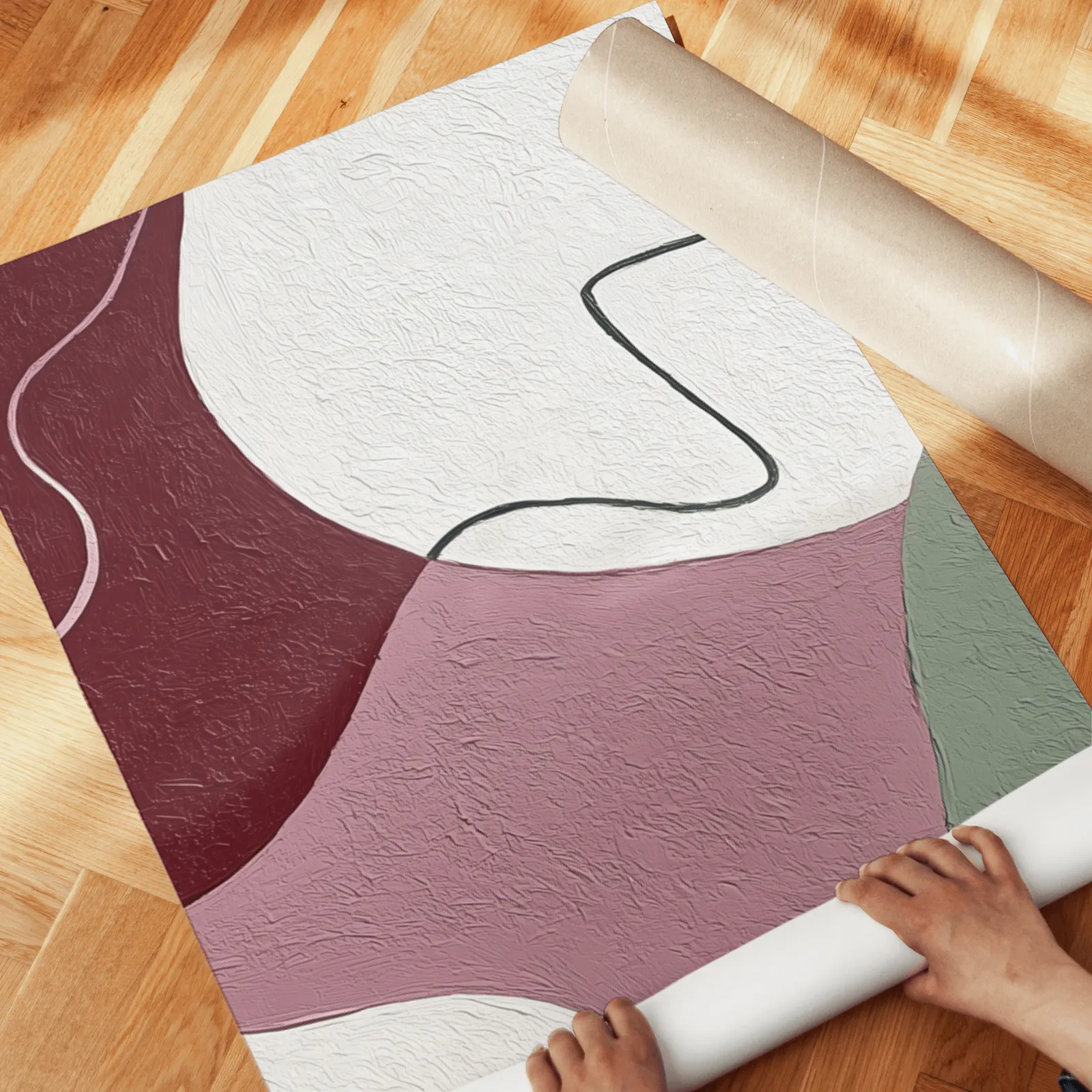 abstract triptych wall art in burgundy and pink, unrolled across a herringbone wood floor by hand