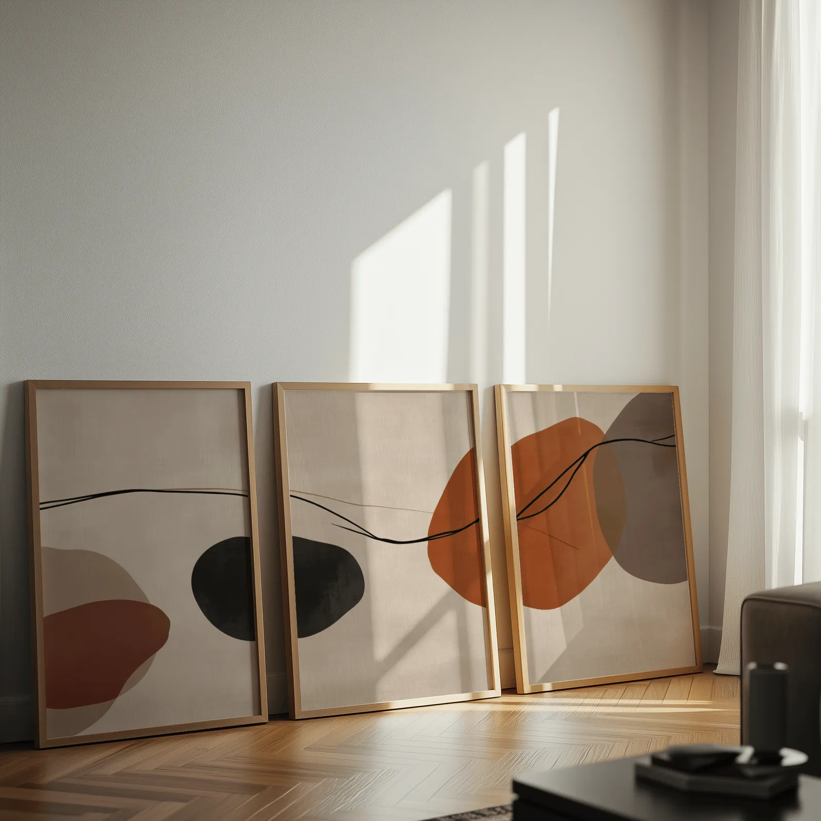 terracotta abstract set of 3 wall art, leaning against a sunlit wall on herringbone flooring