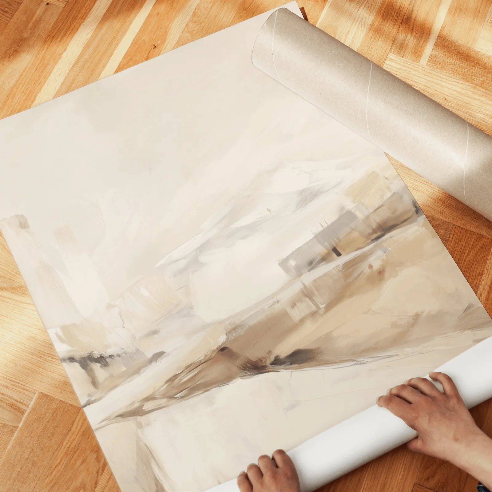 beige abstract landscape wall art set of three, unrolled across a herringbone wood floor by hand