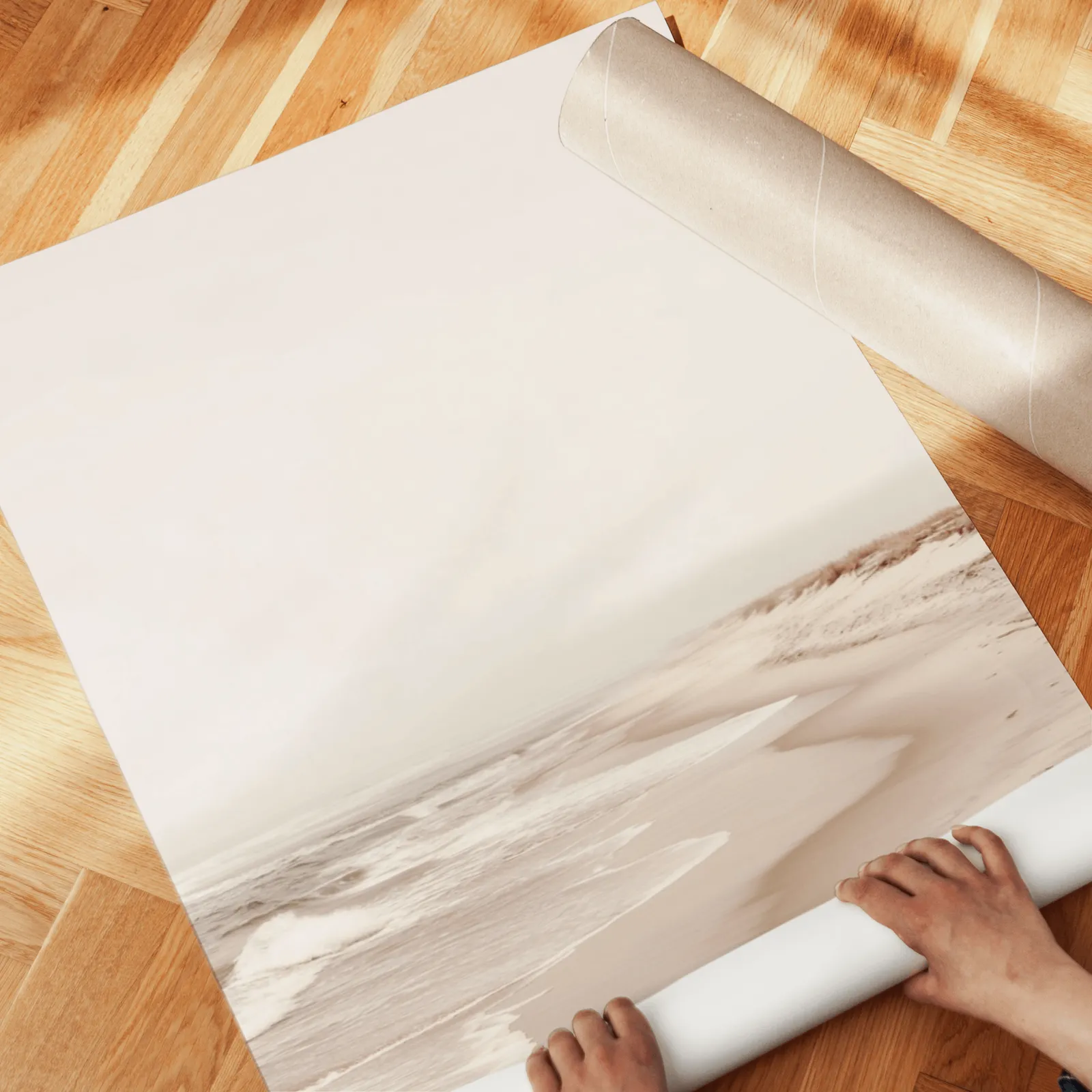 neutral beach wall art set of two coastal prints, unrolled across a herringbone parquet floor by hand