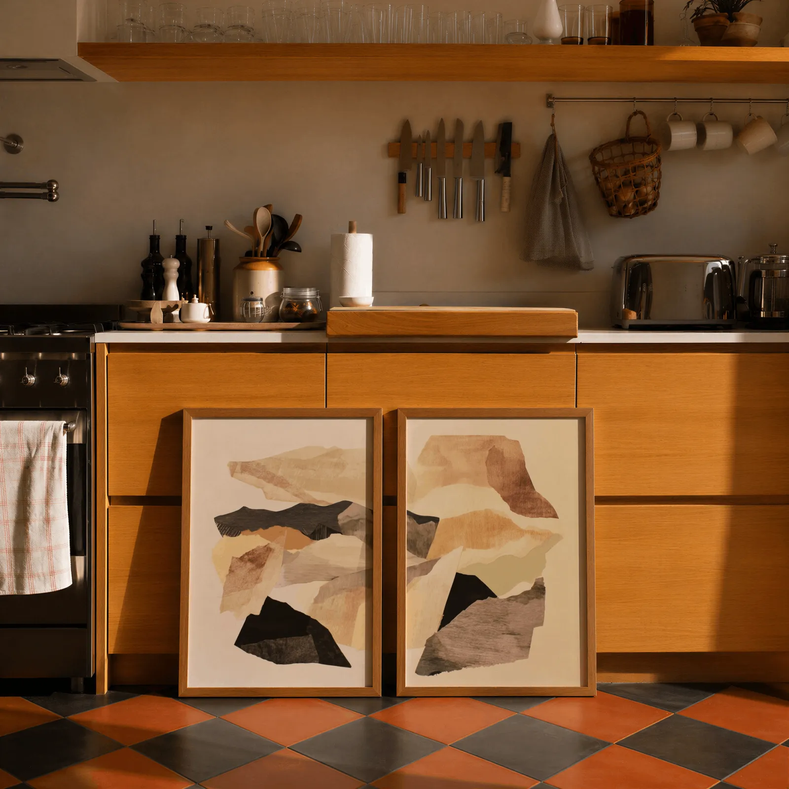 beige abstract wall art set of two, leaning against wooden cabinets on terracotta tiled floor