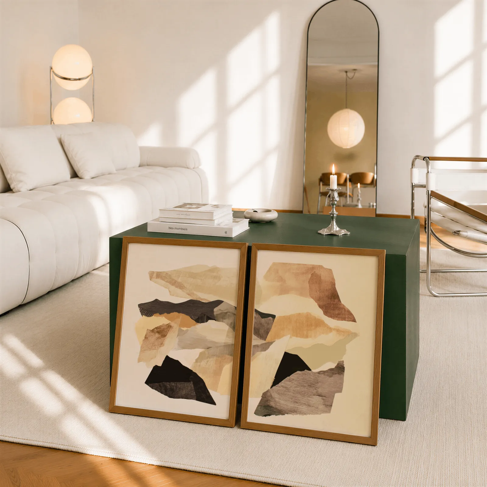 beige abstract wall art set of two, leaning against a dark green cube table beside an arched mirror