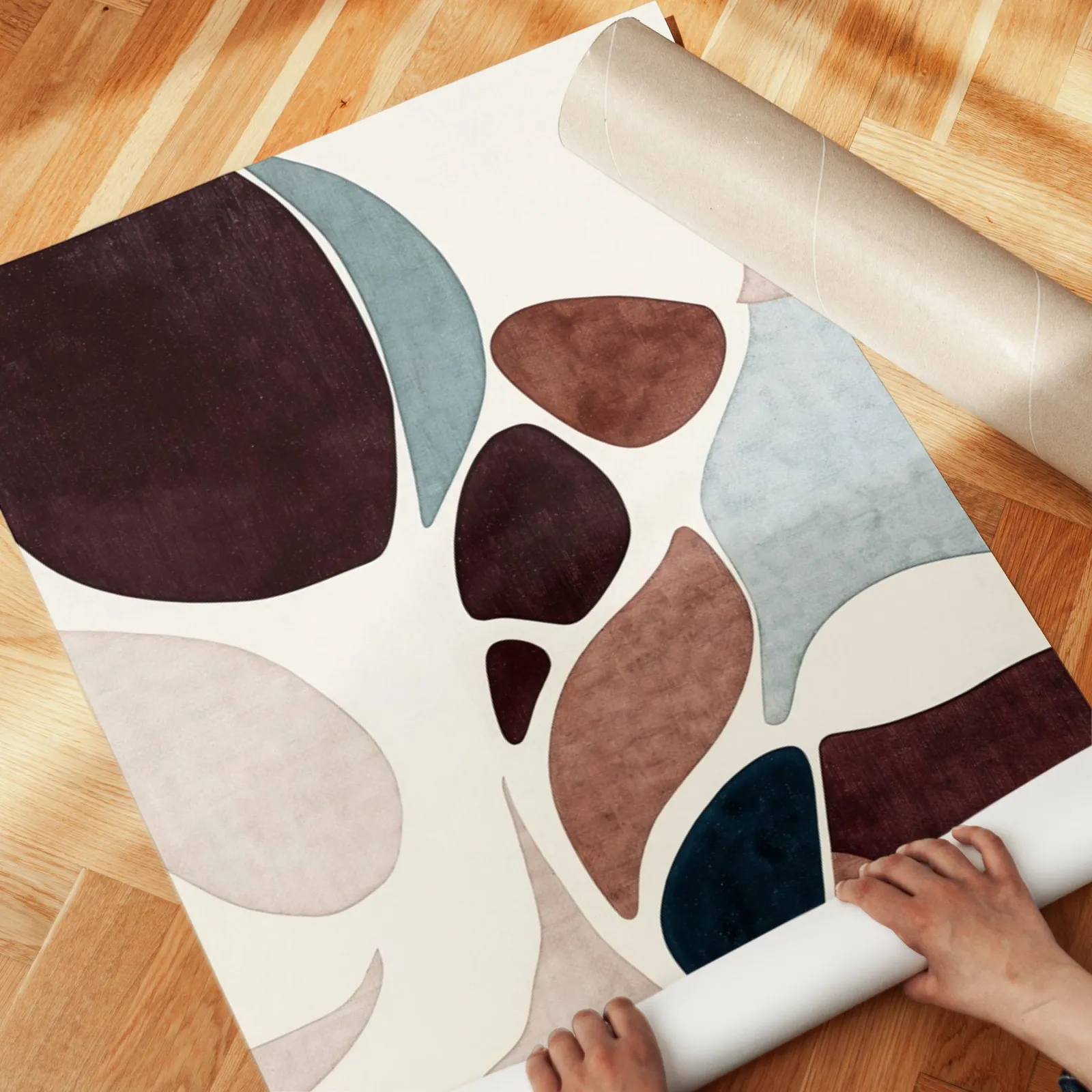 burgundy terracotta abstract organic shapes wall art, unrolled across a herringbone parquet floor by hand