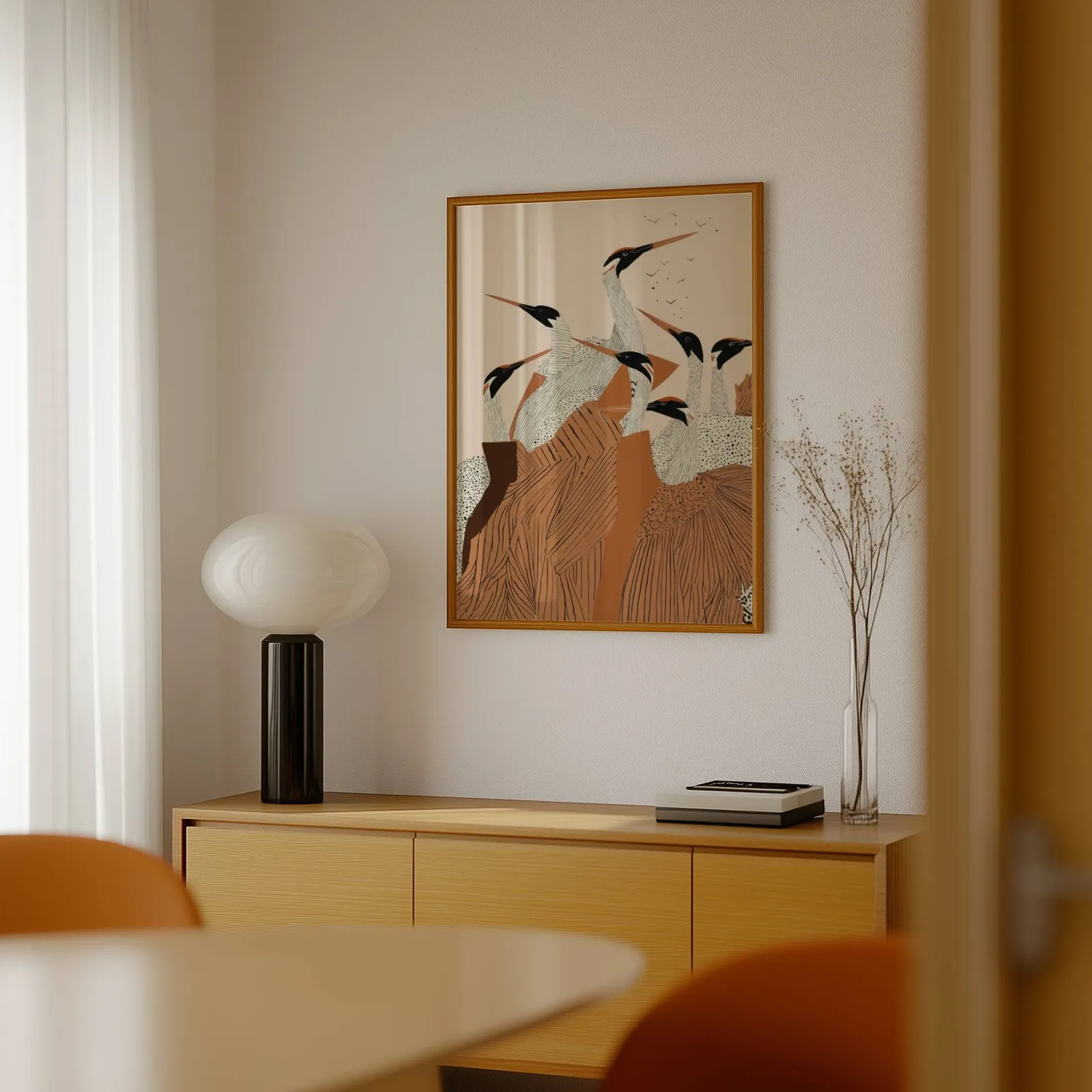 terracotta crane flock nature wall art, above a light wood sideboard beside a bulbous black lamp