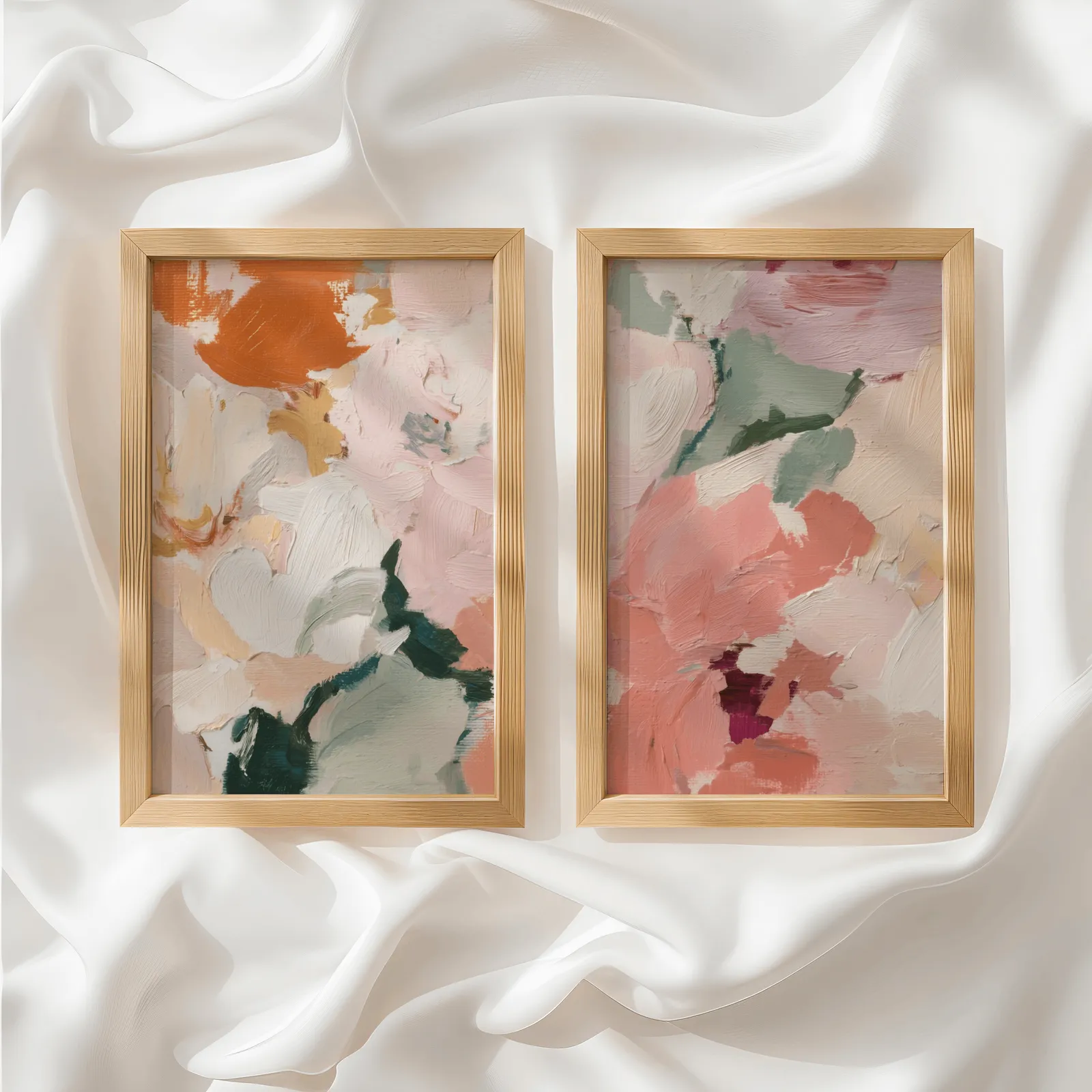 pink and green abstract floral wall art set of two, side by side atop rumpled white silky fabric